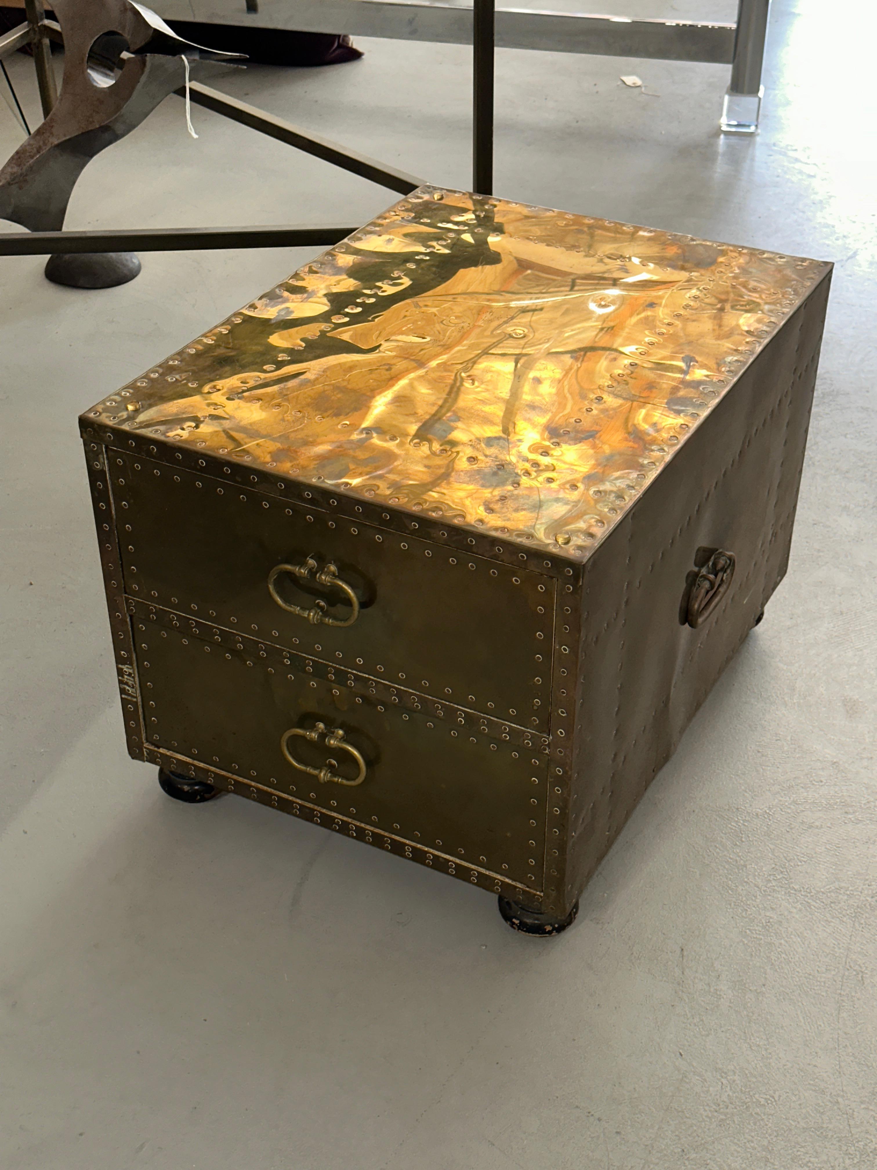 Beautifully worn and patinated brass clad 2 drawer chest or side table by Sarreid Ltd of Spain. Nicely crafted with 2 front facing drawers and handles on the sides. Can be used as an end / side table or as a nightstand in a bedroom. The patination