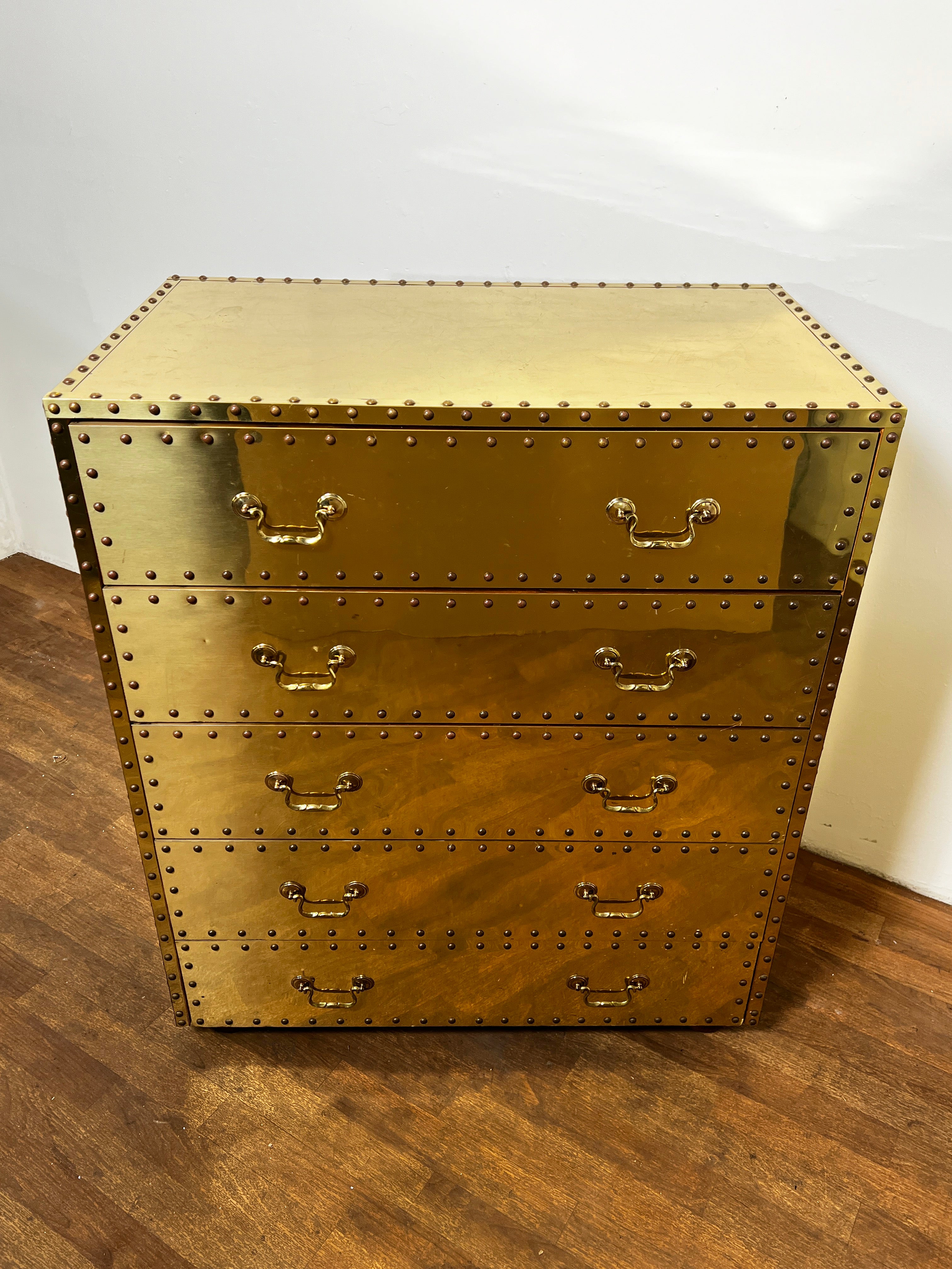 A five drawer brass clad campaign chest on inset bun feet by Sarreid, ca. 1970s.