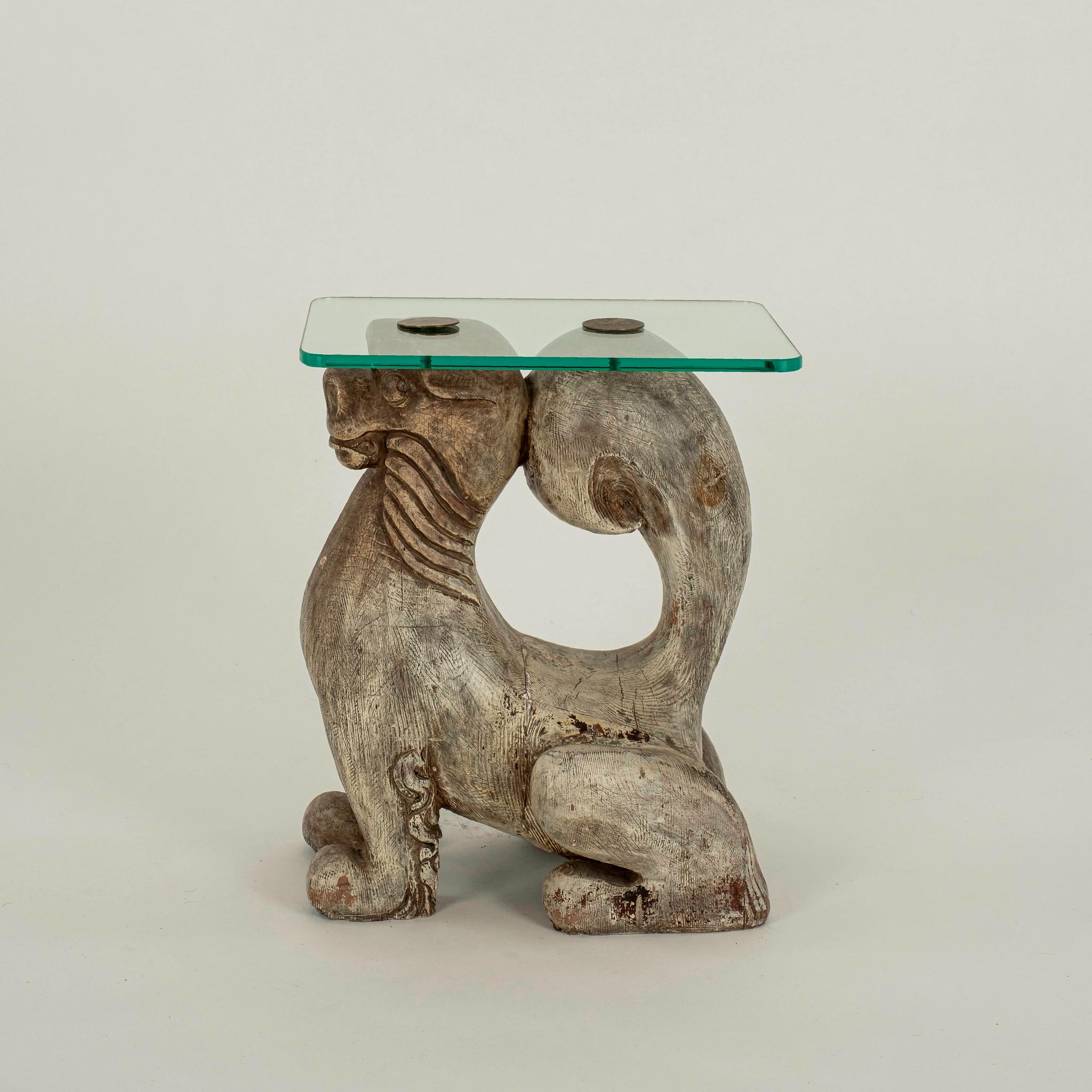 Whimsical 20th century hand carved foo dog table with glass top.