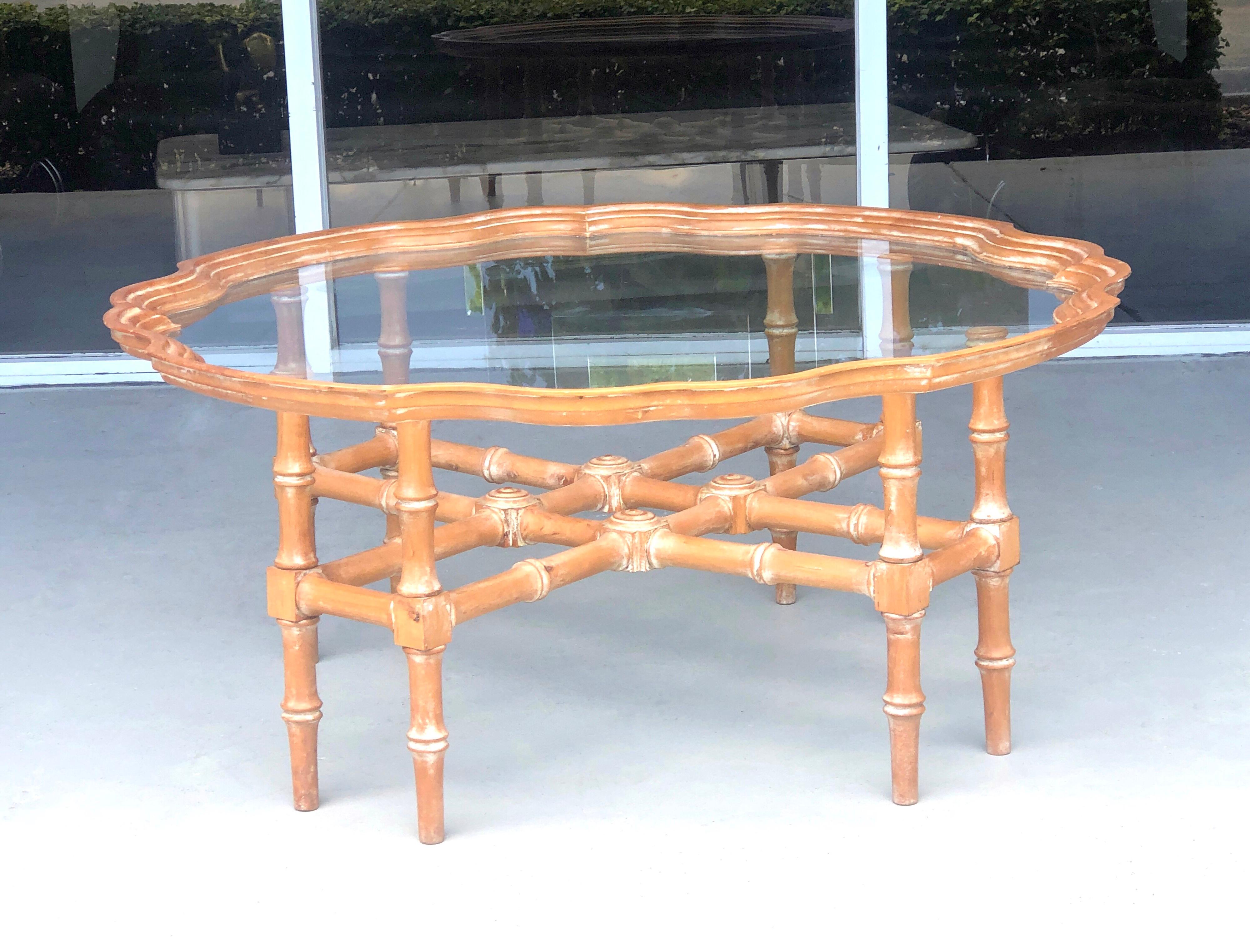 A carved wood coffee table, the removable glass top has a carved wood edge. A modern take on a Classic design.