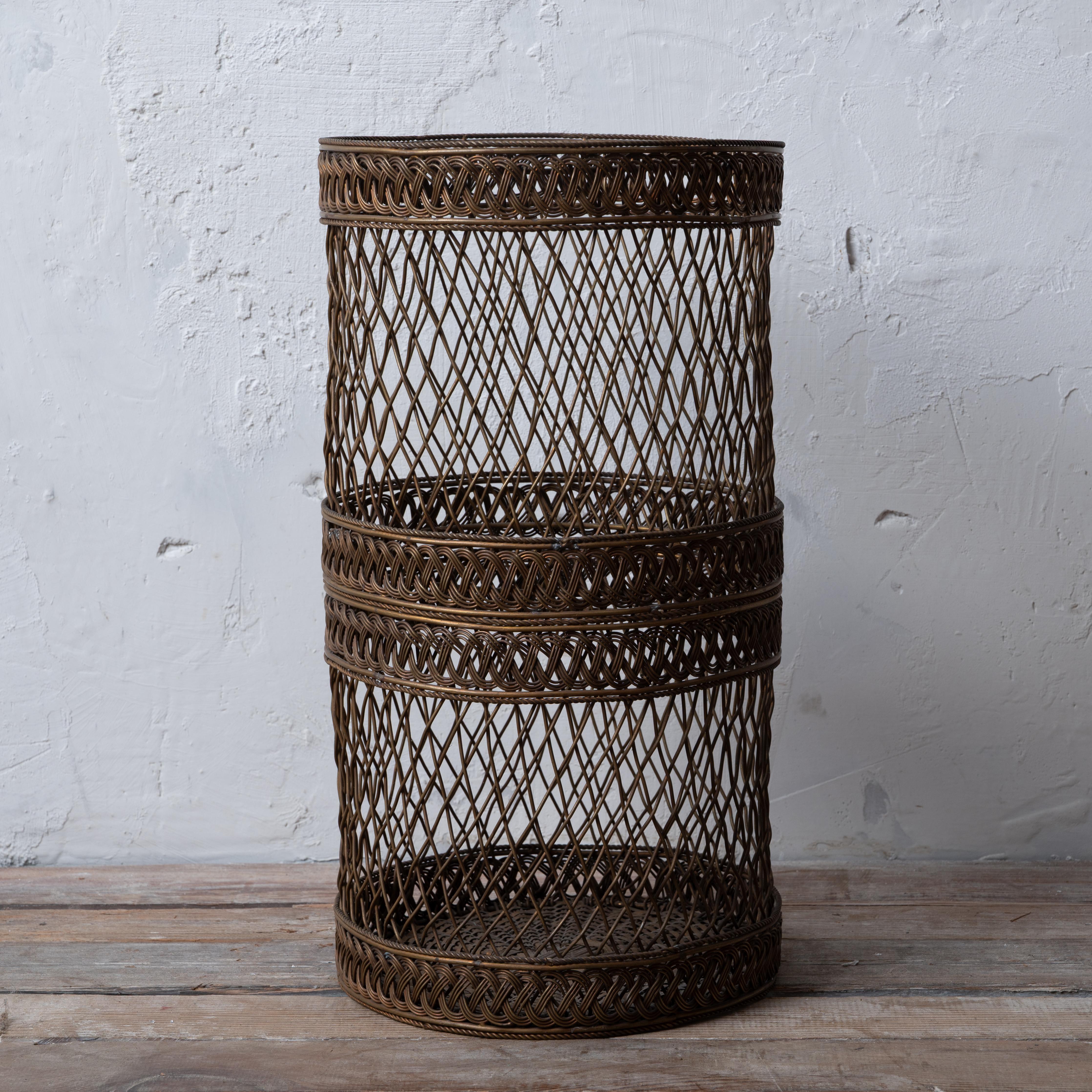 A Sarreid woven brass waste basket.  



9 ½ inches wide by 17 ½ inches tall




