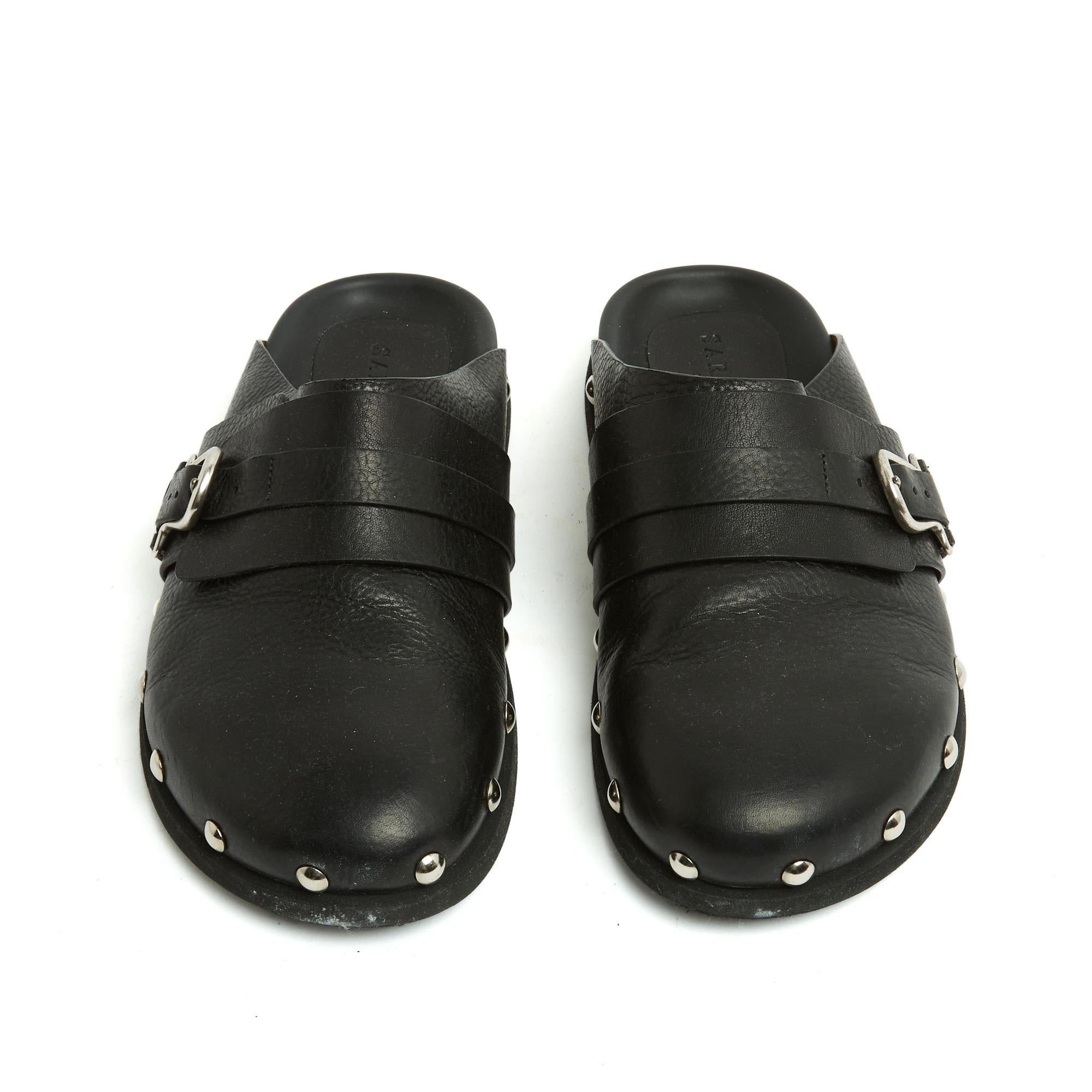 Sartore mules or clogs in black leather decorated with silver metal studs, black leather insole, black rubber outsole. Size EU38 or UK5 and US7.5 but they do not fit very large. The shoes have been worn only once and they are in very good condition,