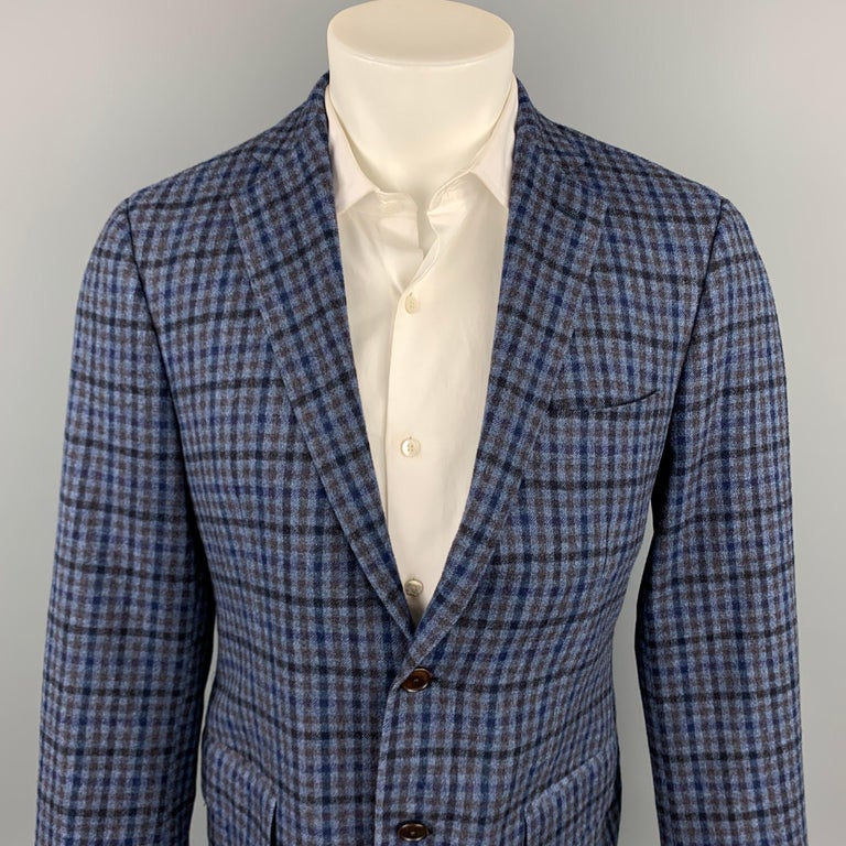 SARTORIA PARTENOPEA sport coat comes in a navy & blue plaid wool / cashmere with a full liner featuring a notch lapel, flap pockets, and a two button closure. Made in Italy.

Very Good Pre-Owned Condition.
Marked: R

Measurements:

Shoulder: 17.5