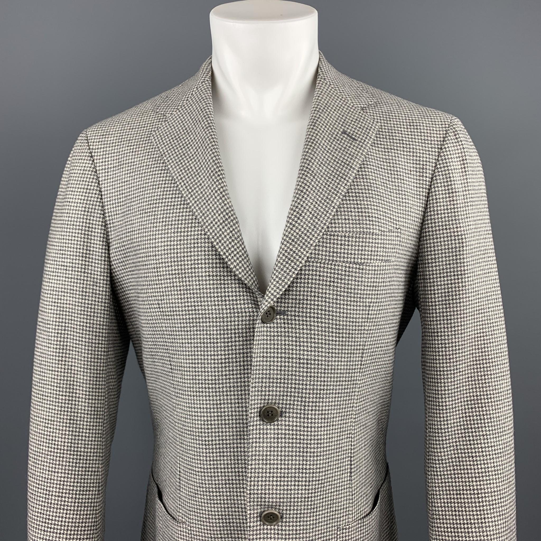 SARTORIO sport coat comes in a gray houndstooth wool / cashmere featuring a notch lapel, patch pockets, and a three button closure. Made in Italy.

Excellent Pre-Owned Condition.
Marked: IT 48

Measurements:

Shoulder: 16 in. 
Chest: 38 in.
Sleeve: