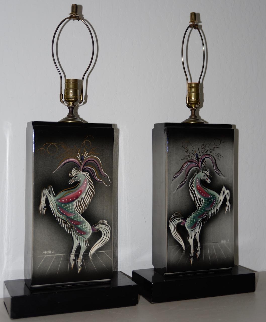 Sascha Brastoff (1917–1993) Pair of extraordinary hand painted glazed ceramic lamps, circa 1960.

Beautiful matching pair of highly decorated horses with metallic highlights.

This pair of lamps are in excellent vintage condition.

Wired,