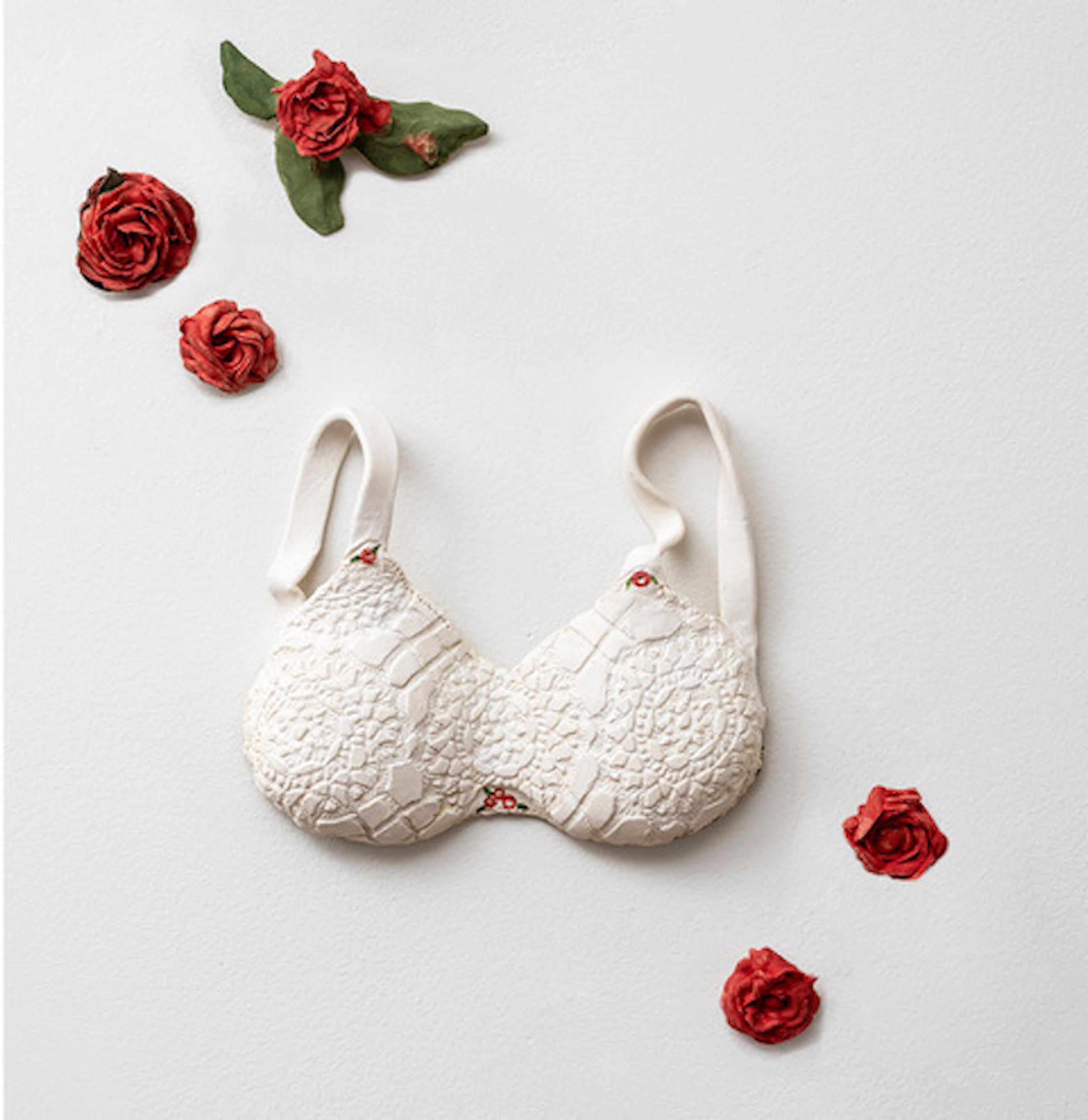 Sascha Mallon Still-Life Sculpture - "Innocence" white porcelain lace brassiere with red roses wall installation