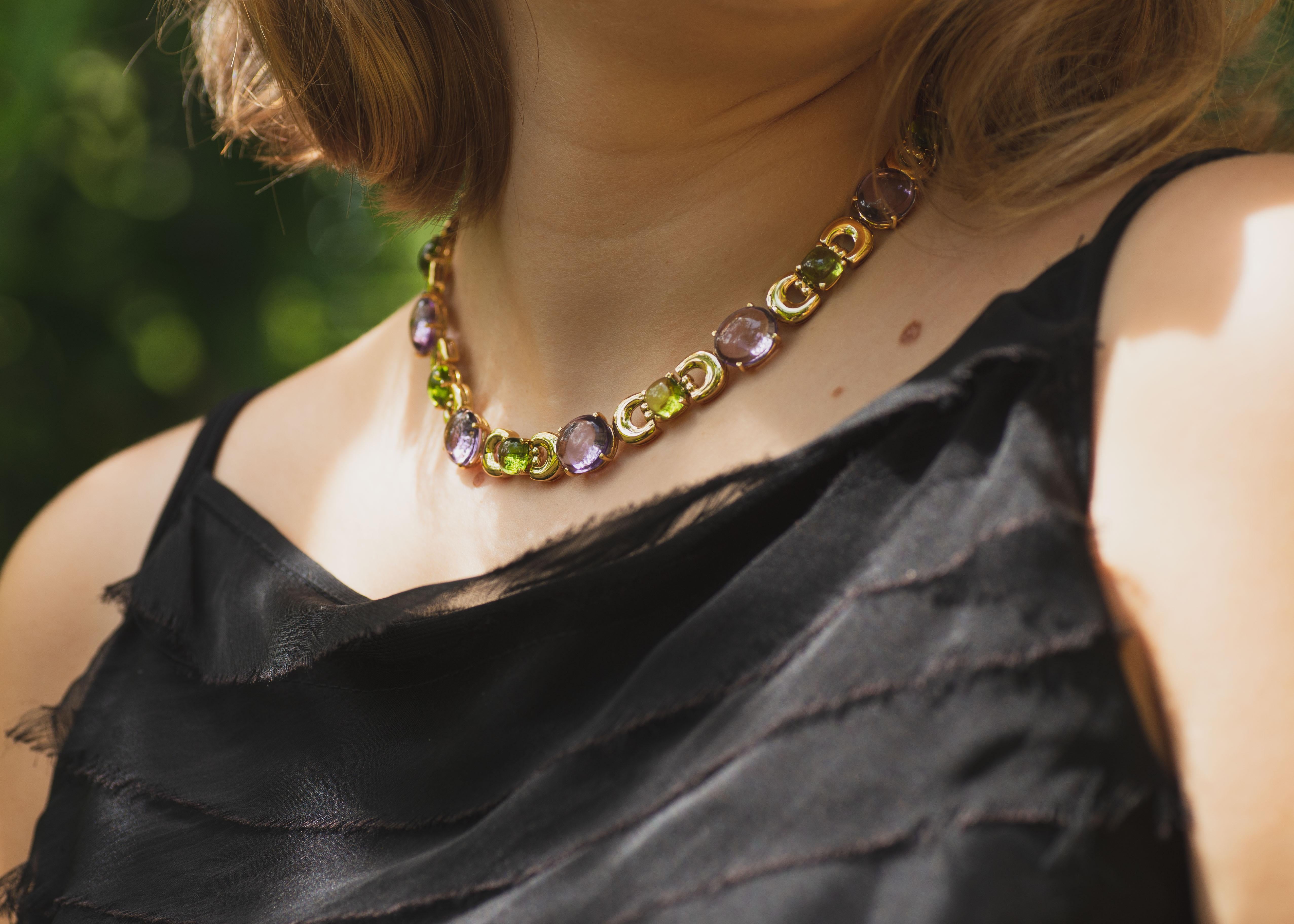The breathtaking Secret of Berenice Necklace radiates sophistication, showcasing eleven exquisite, almond-cut Amethysts and ten cushion-cut, lime-green Peridots. This elegant necklace is infused with a dash of Italian flair that defines the