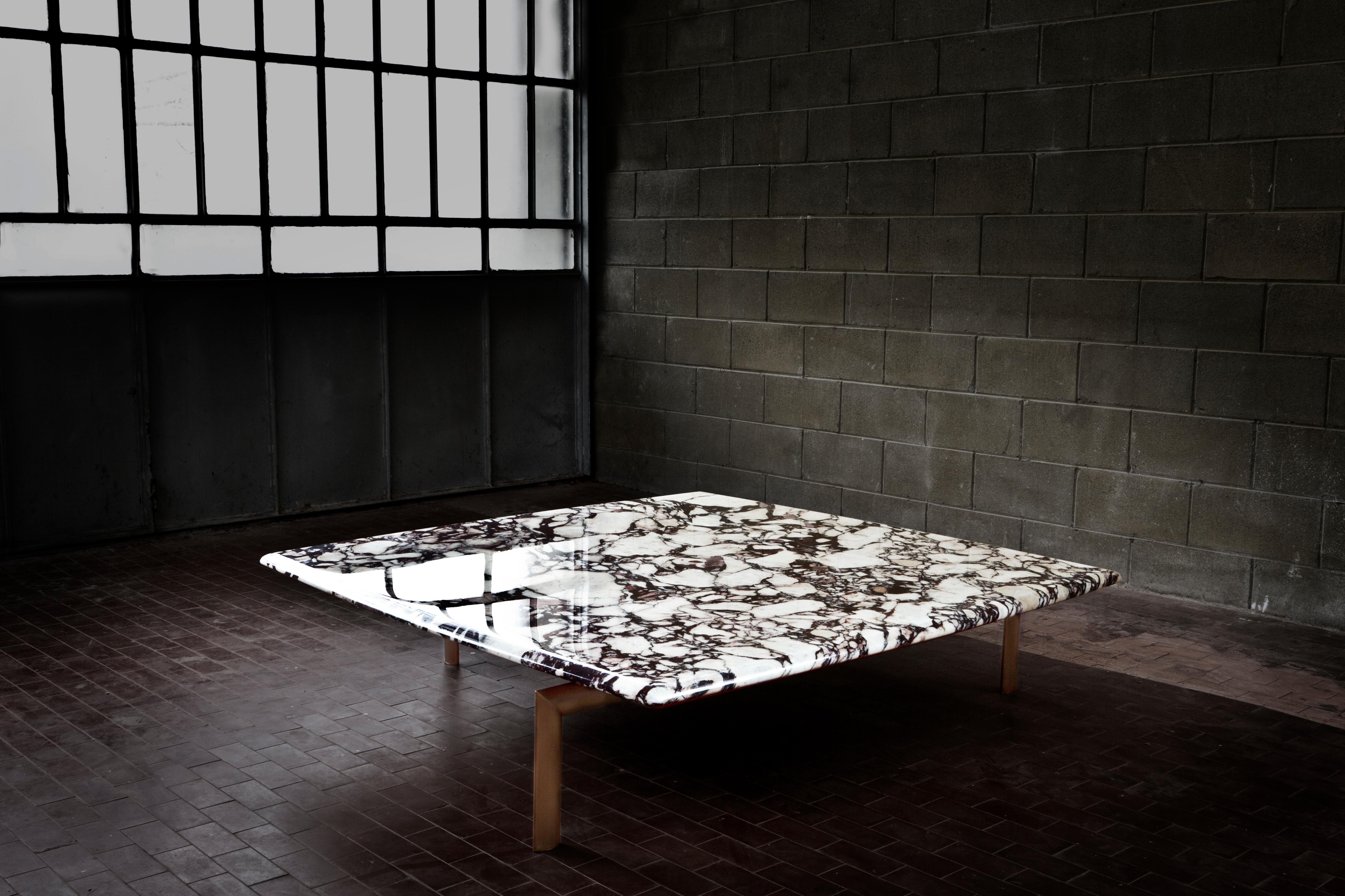 A truly spectacular coffee table, made of Breccia Medicea marble, with dark bronze legs.The asymmetry of the structure is the principal characteristic of the base, over which cantilevers, seemingly without obeying gravity, a heavy slab of marble,