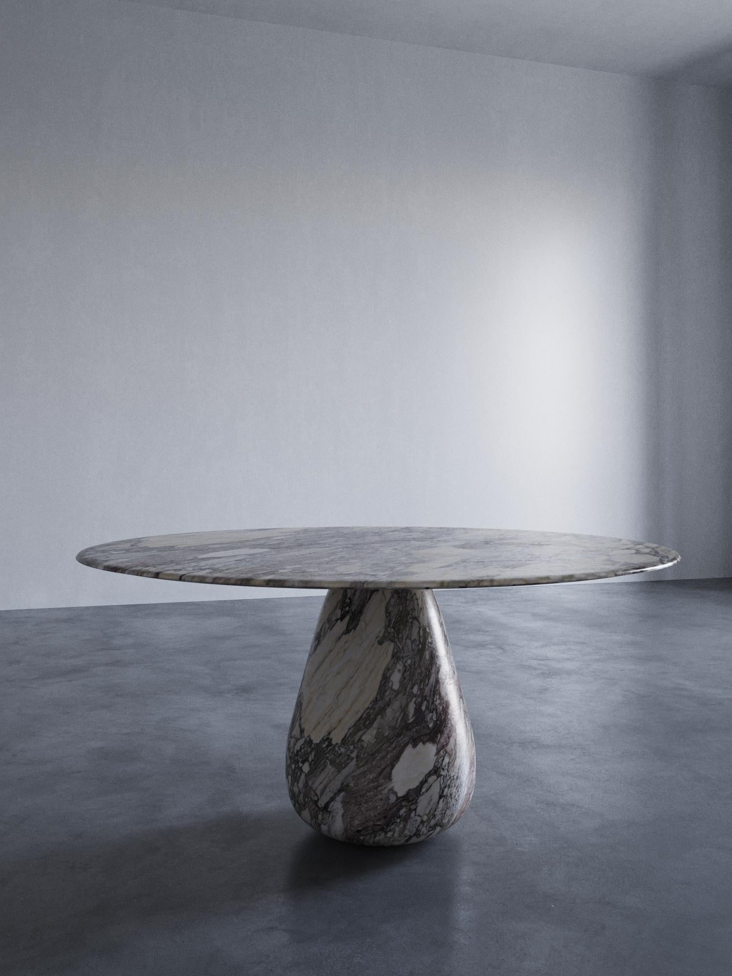 Sasso Marble Dining Table by ​STUDIO IB MILANO
Signed
Dimensions: D 150 x H 75 cm.
Materials: Arabescato Rosa marble.

Also available in other stones.

Behold the awe-inspiring presence of the SASSO dining table, a monolithic marvel that showcases