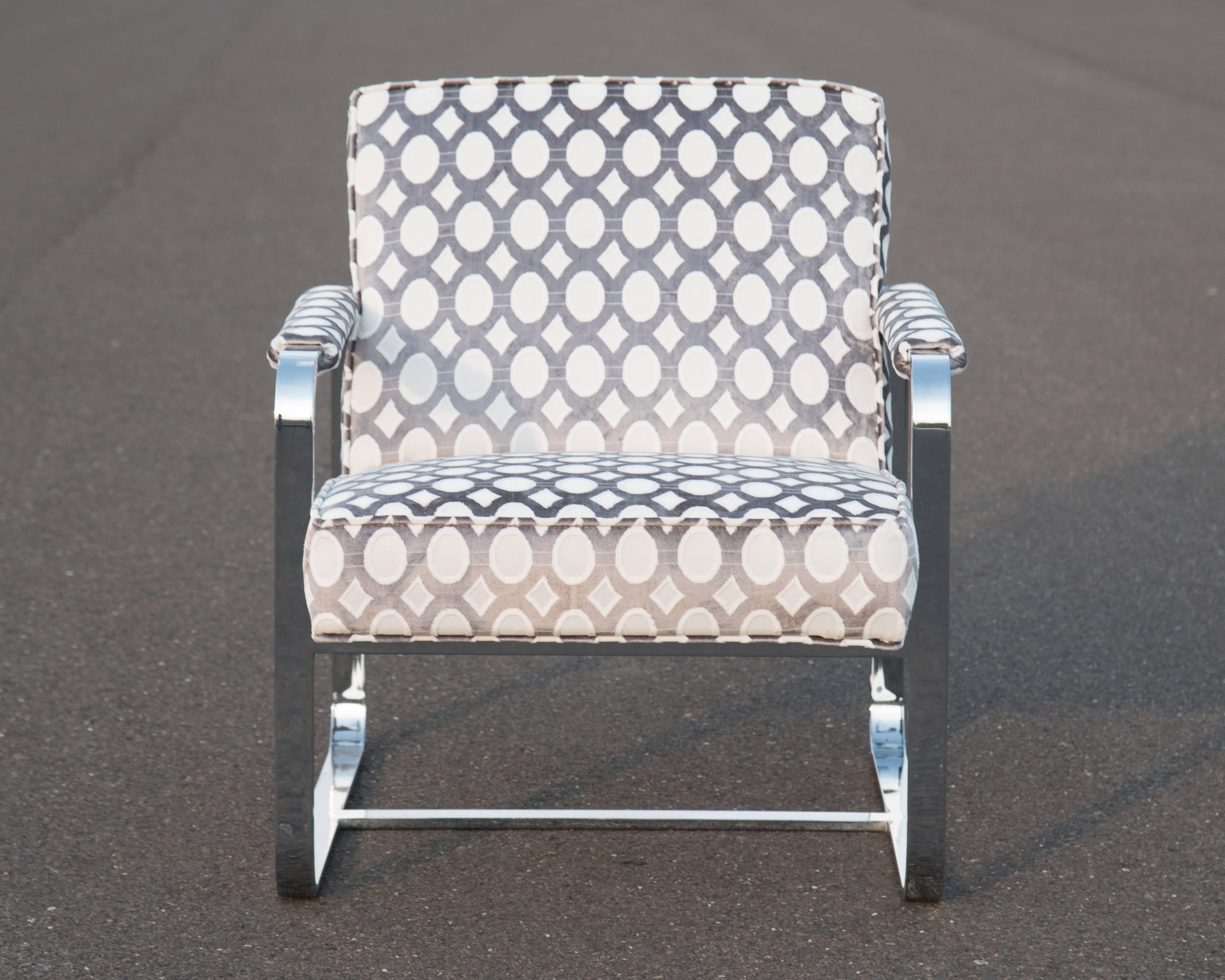 Milo Baughman style longue club chair having sleek stainless steel frame with new sassy geometric upholstery. Seat cushion is attached. Measures: Seat H 16.5