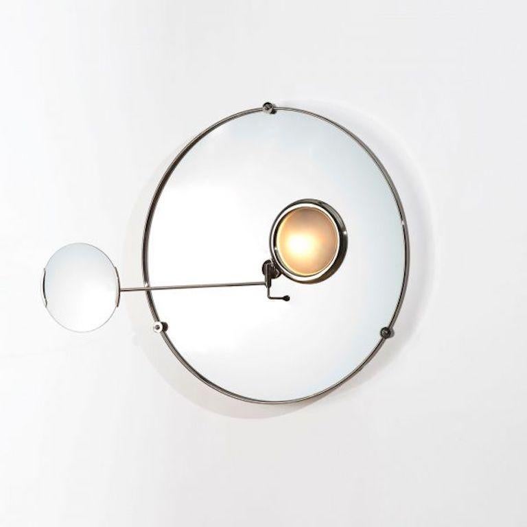 Satellite mirror by Eileen Gray for Ecart. Originally designed in 1927. Current production designed and manufactured in France. Nickel plated brass structure, mirror, sanded convex glass cover. The magnifying mirror is maintained by two blocking