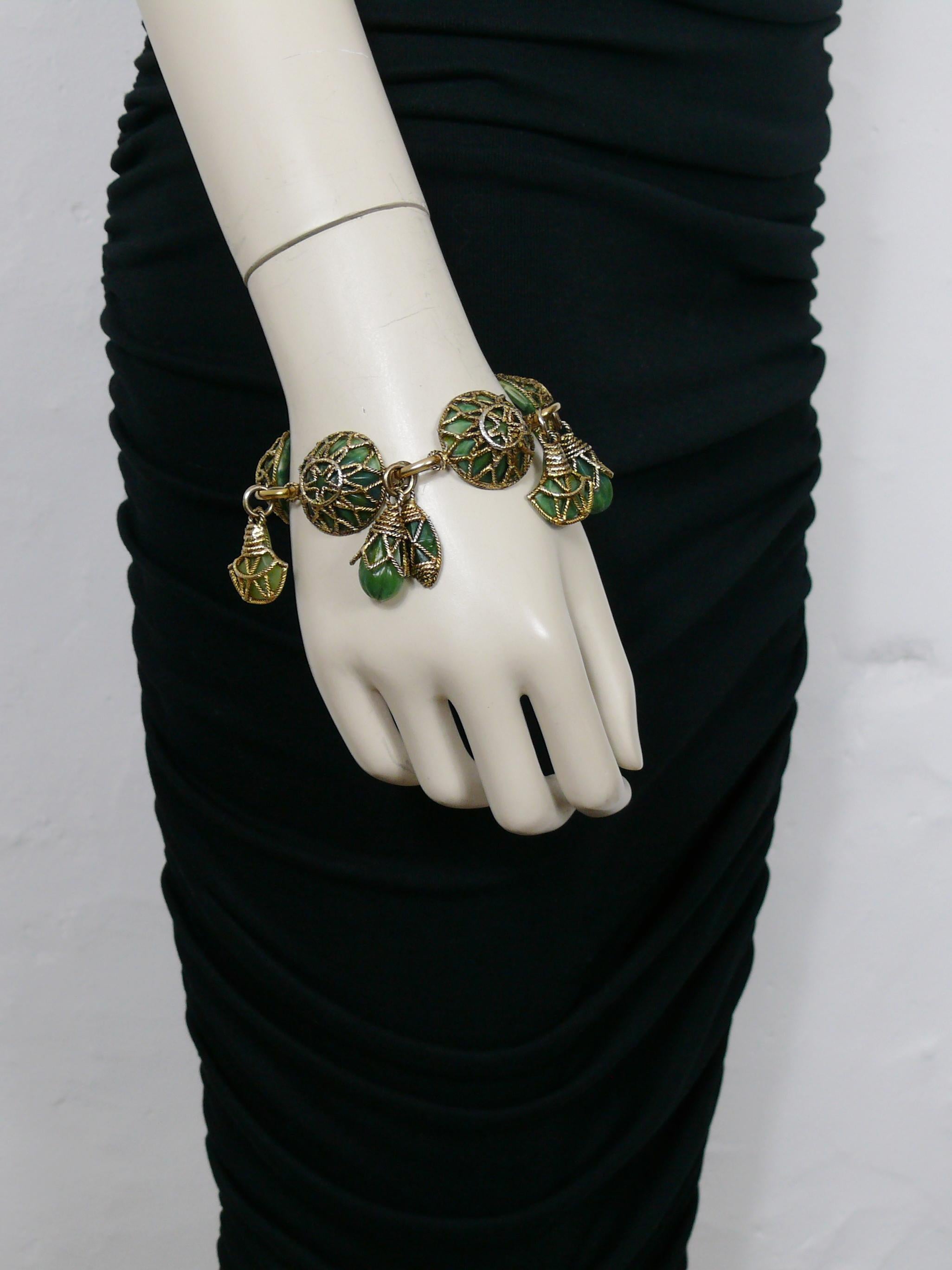SATELLITE Paris vintage antiqued gold toned bracelet featuring domed filigree links and charms embellished with faux jade resin cabochons.

T-bar closure.

Embossed SATELLITE.

Indicative measurements : length approx. 21 cm (8.27 inches).

NOTES
-