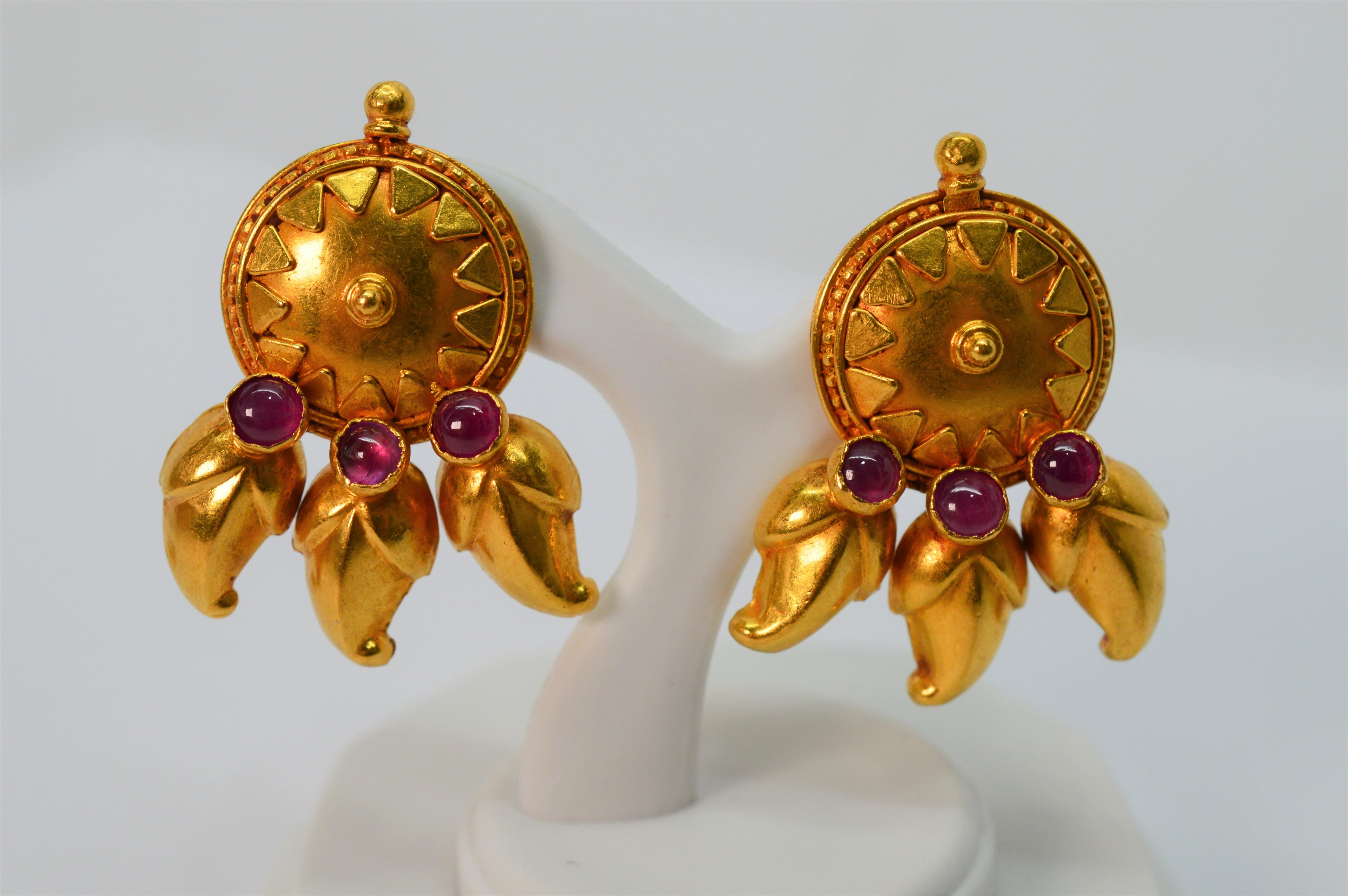 The soft satin finish highlights the Far East artisan features of these 22 Karat yellow gold medallion earrings. In a stud style, this regal pair measures 5/8 inch / approximately 16mm, and has a decorative gold medallion design that is accented
