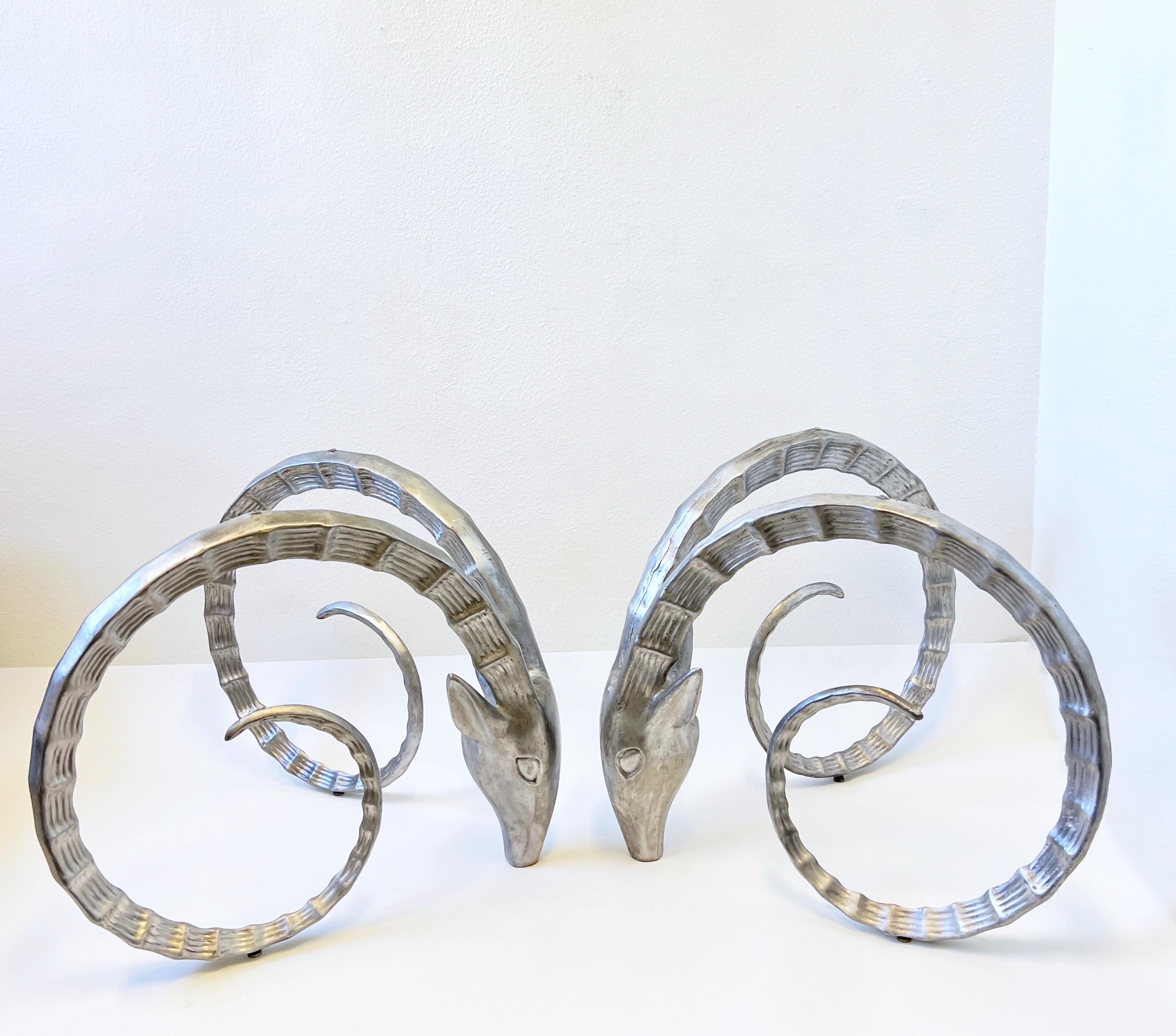 Amazing pair of cast aluminum rams head dining table bases from the 1980’s. 
They have a satin finish, can be polished or powder coated if desired. 
You can use a rectangular or round top on them. 
We can order a glass top for an additional price