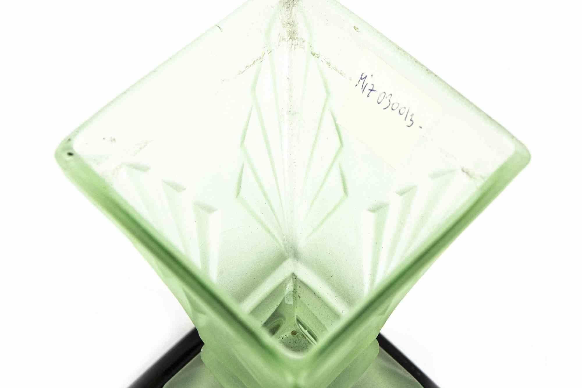 Satin Art glass centerpiece is an original decorative object realized in the mid-20th century.

Made in Italy.

The base has been in black ceramics. On the base there is a glass piece and, the centerpiece is realized in green satin art glass.