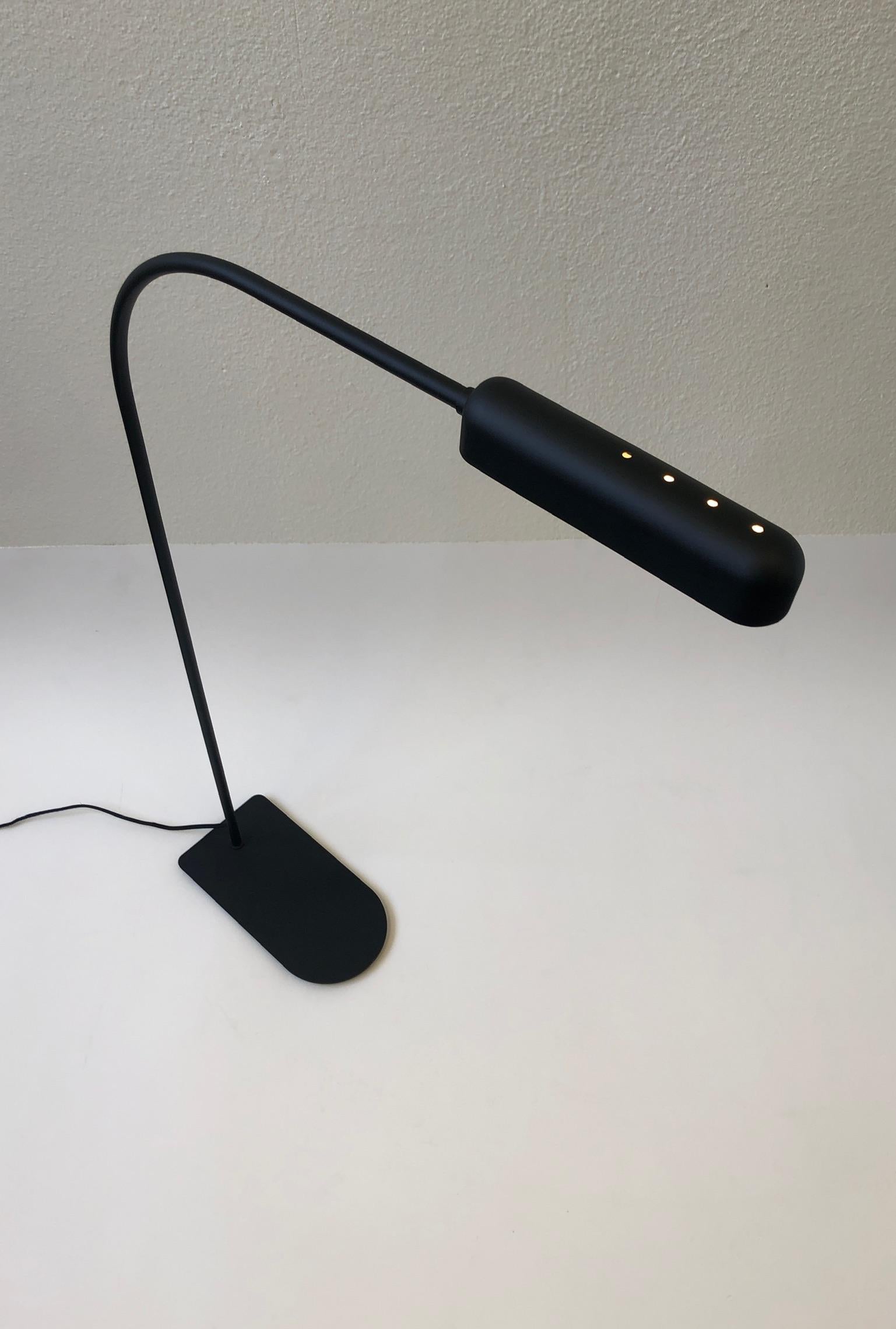 A rare 1980s satin black reading floor lamp by Ron Rezek. The lamp is in excellent condition. Newly rewired with black cloth cord. The lamp has a full range dimmer. It takes a 60 watt bulb since the shade just sits on top of the bulb.
Overall