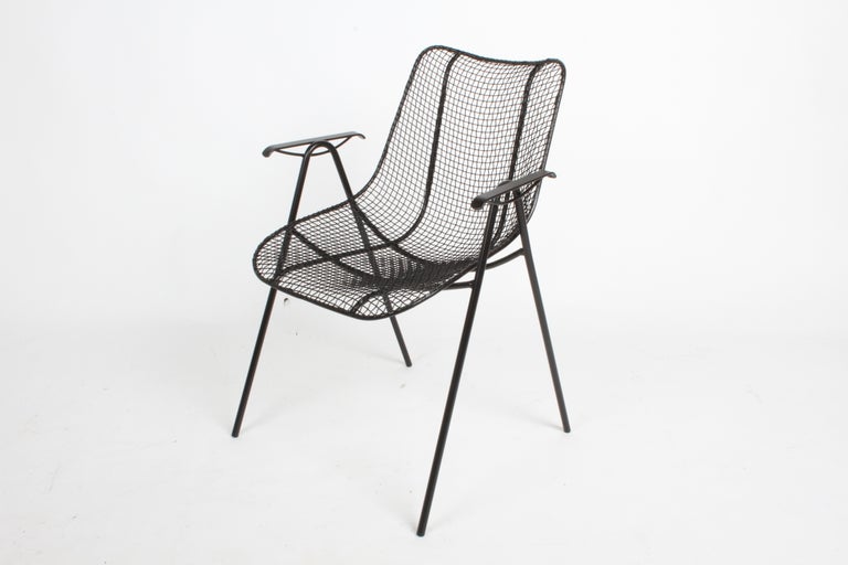 Satin black Woodard sculpture mesh dining chairs with arms, restored condition. Each chair has been sand blasted, dipped in rust inhibitor primer and painted in satin black. Arm height is 25