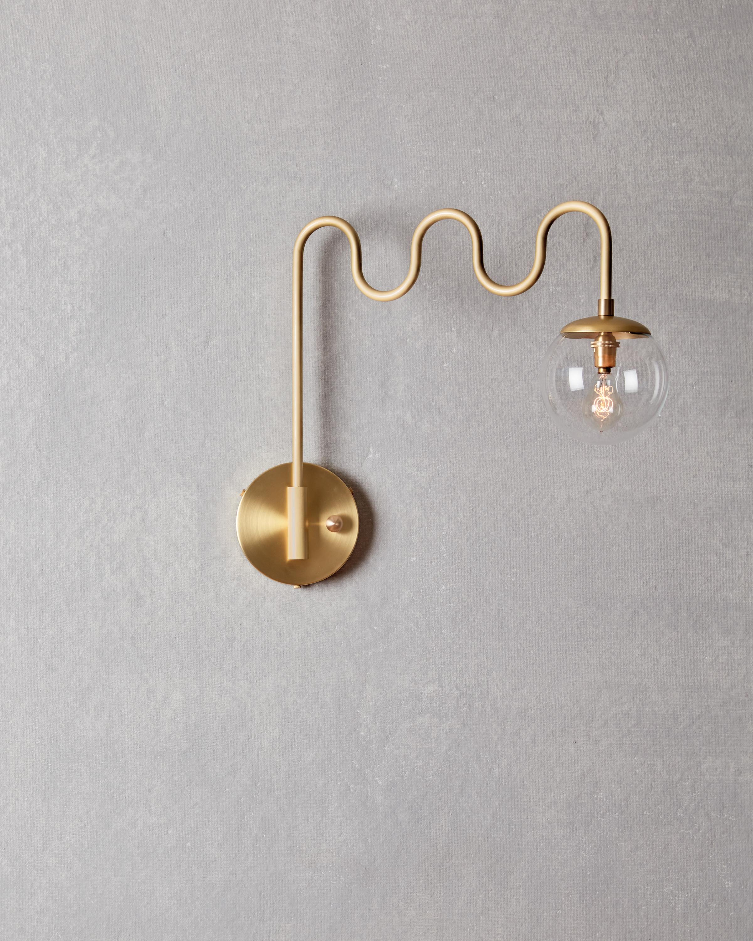 Form and function meet with the Cecil Sconce’s undulating bent brass arm and swiveling backplate. Choose either a milk glass globe for ambiance or a clear glass globe for maximum illumination. 

OVERALL DIMENSIONS
17.75