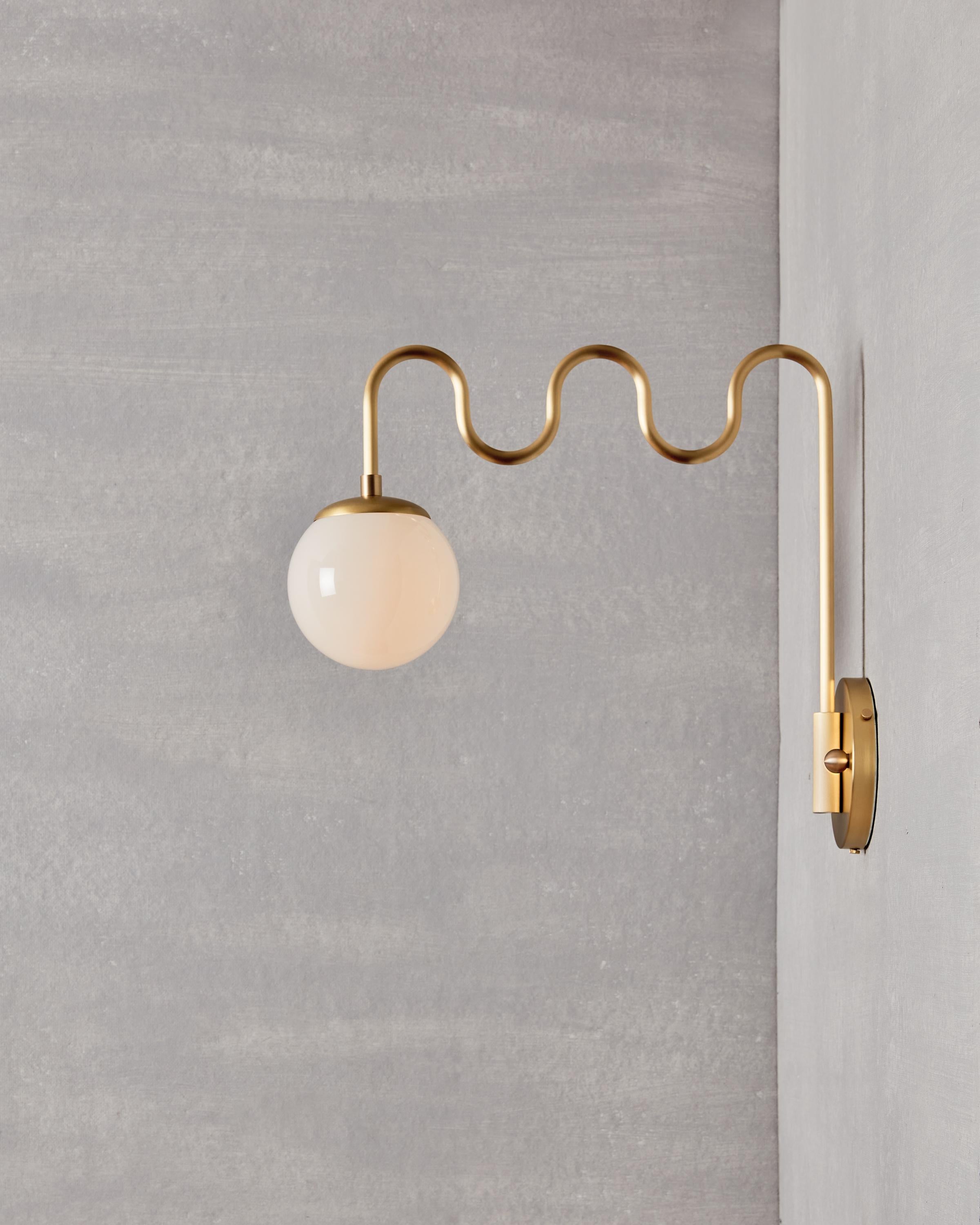 Form and function meet with the Cecil Sconce’s undulating bent brass arm and swiveling backplate. Choose either a milk glass globe for ambiance or a clear glass globe for maximum illumination. 

OVERALL DIMENSIONS
17.75