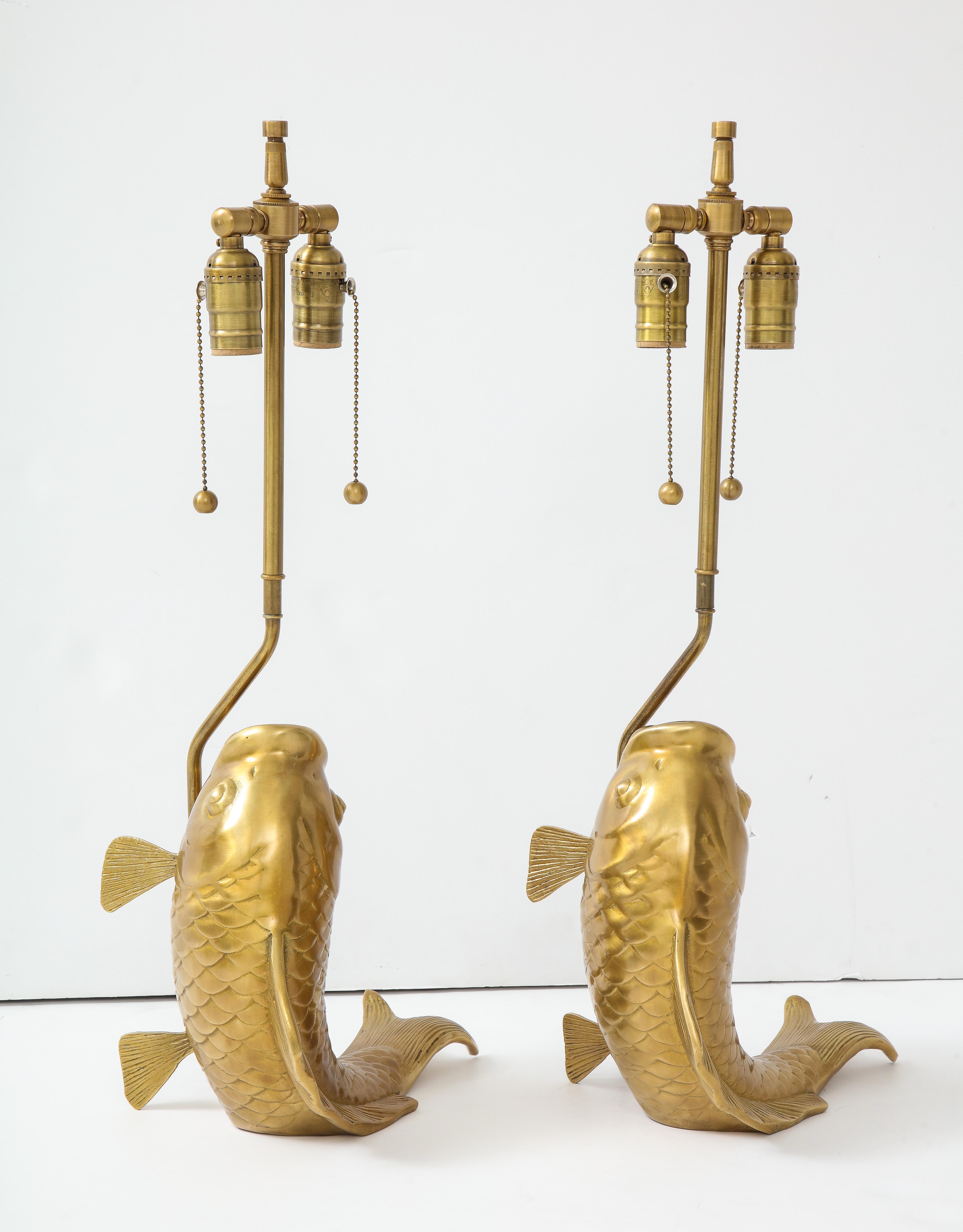 Pair of hand finished cast brass stylized koi fish lamps with detailed scales and fins. Rewired for use in the USA.