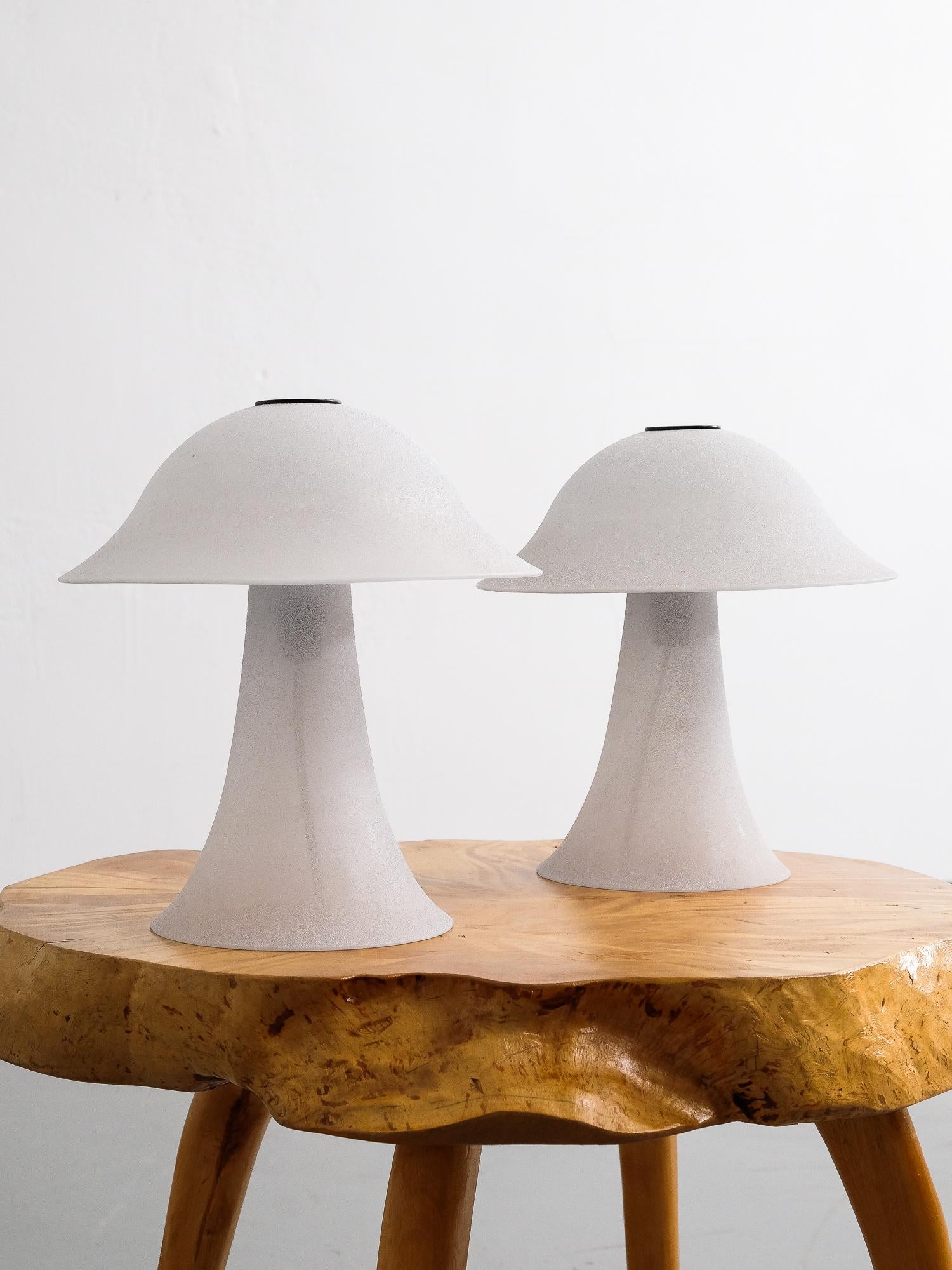 Peill & Putzler pair of vintage ‘Mushroom’ table lamps made in Germany, circa 1970s. Both lamps consist of a quality hand blown glass base and shade which is fastened with a black circular plate at the top. The light grey glass has an elegant