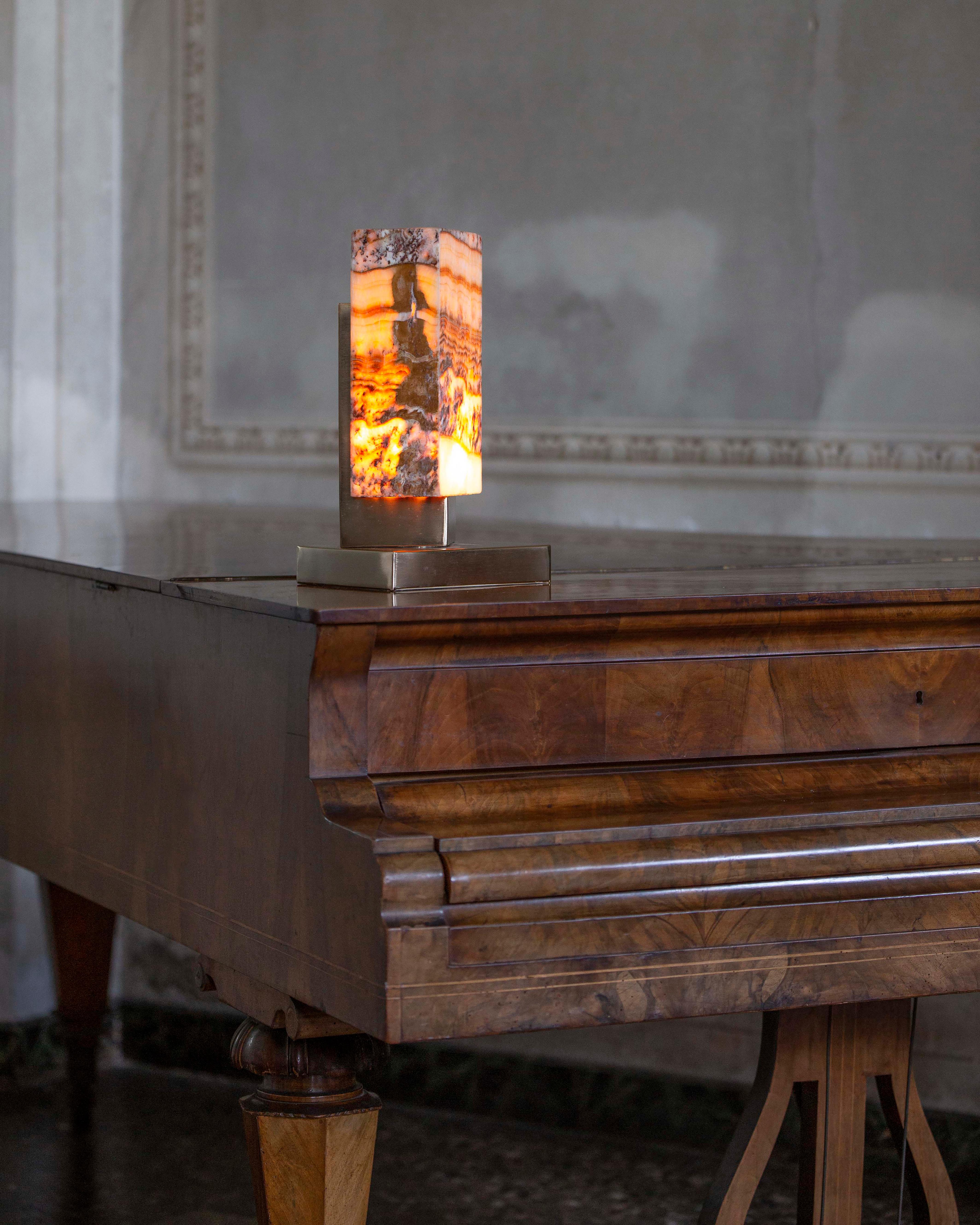 Lampe de table Naica en or satiné de G.Luce
Dimensions : L 21 x D 19 x H 36,5 cm
MATERIAL : Structure en acier finition or satiné clair, diffuseur en onyx tigré. 
Poids : 4.2 Kg. 

G.Luce est le résultat de trente ans d'engagement, de recherche et