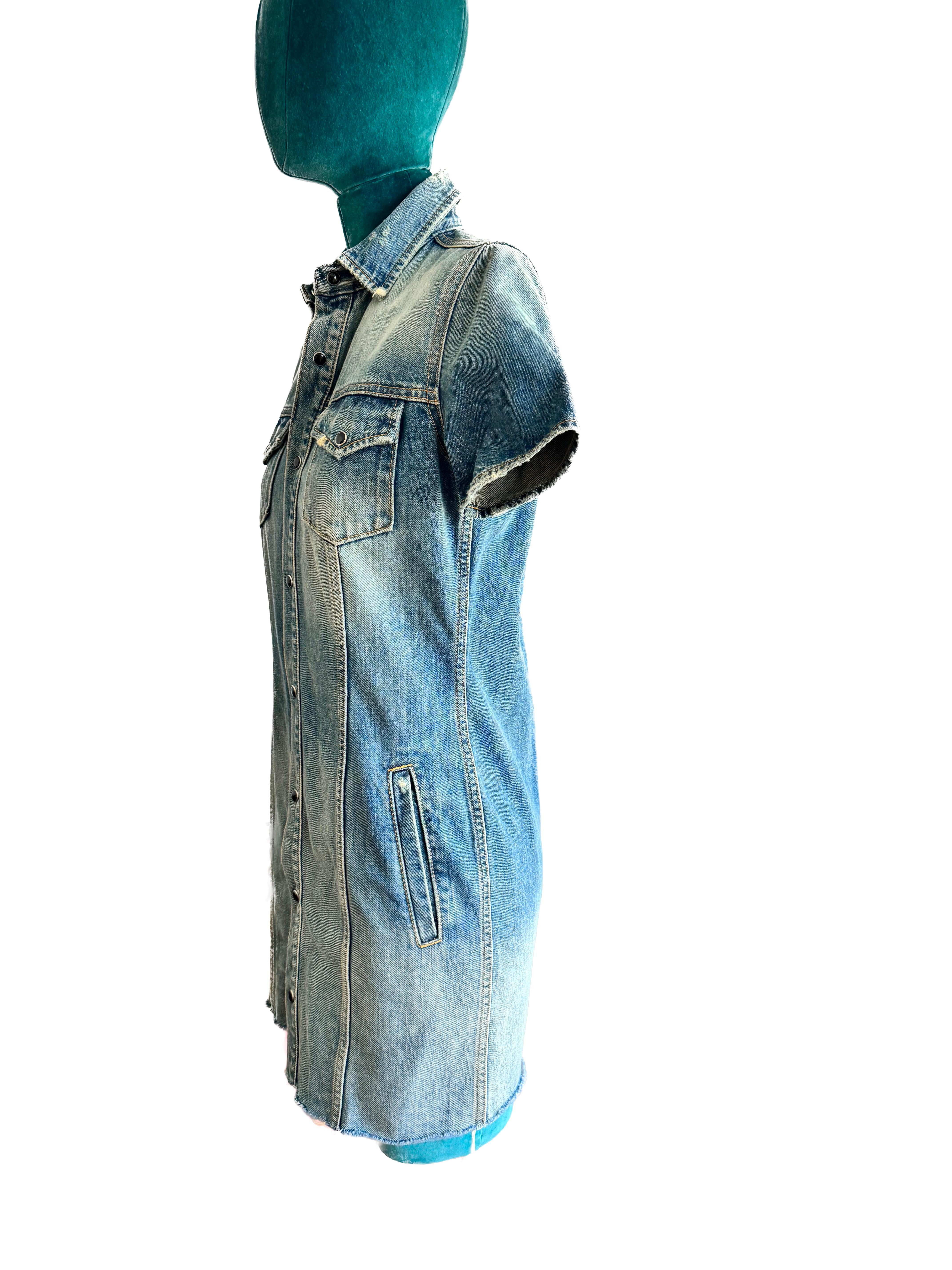
ChatGPT
The Saint Laurent distressed denim shirt dress in size XS embodies a vintage-inspired yet contemporary aesthetic, offering a fusion of casual elegance and edgy detailing.

Crafted from high-quality distressed denim fabric, this shirt dress