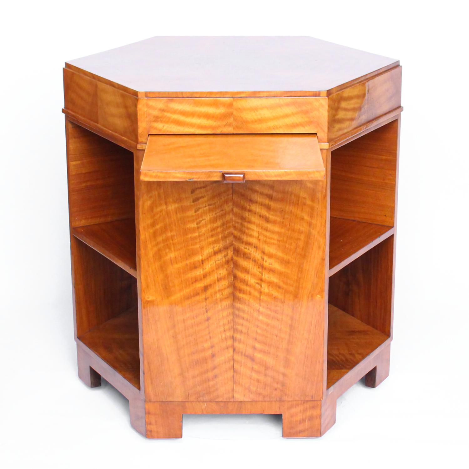 An Art Deco, satin wood veneer hexagonal library table with three integral sliding trays, attributed to Heal's. 

Origin: England

Date: circa 1935
 