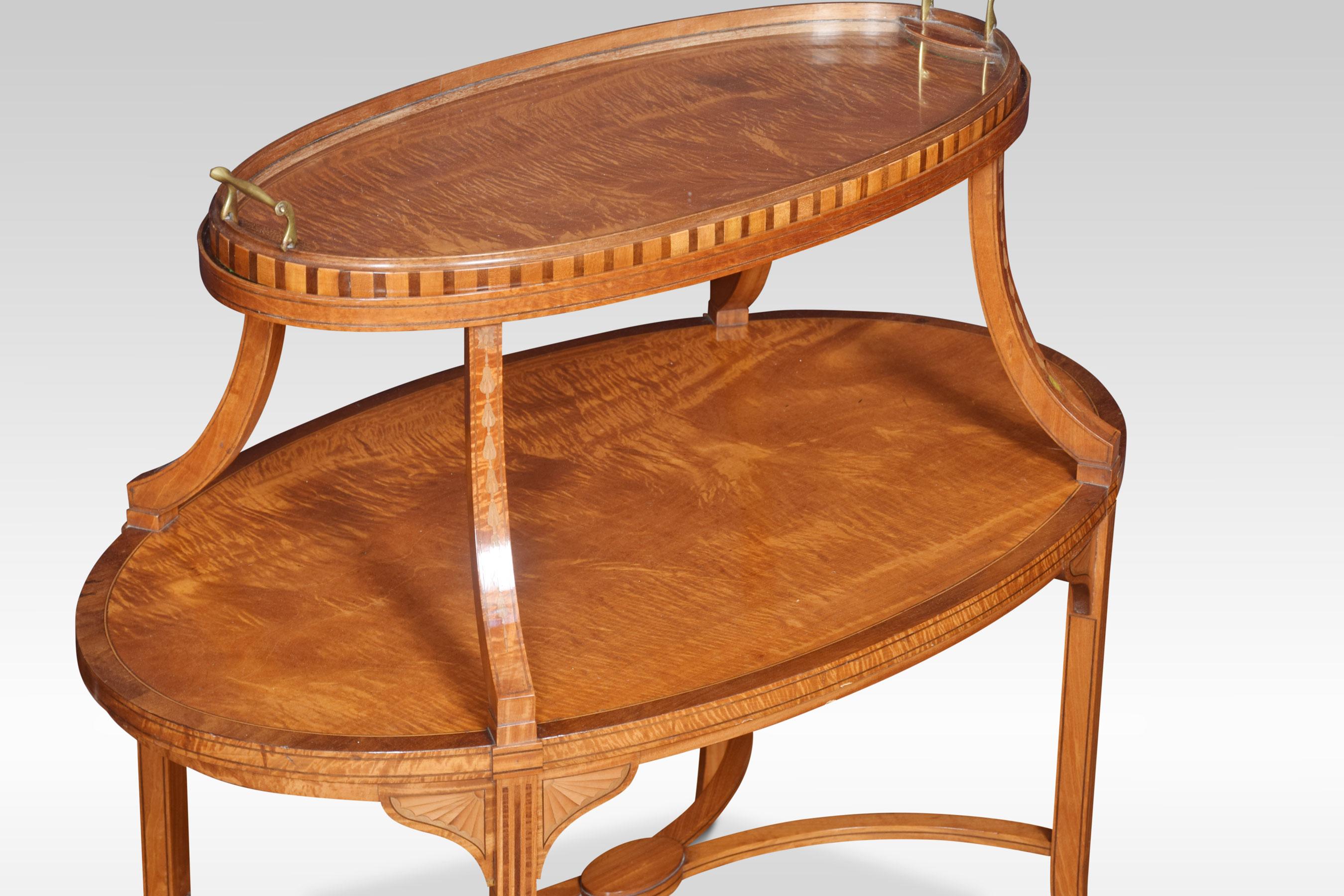 Satinwood and mahogany étagère, the top fitted with a removable oval glass-paneled tray, above under tier raised up on square block tapered and splayed legs, united by curved stretchers.
Dimensions:
Height 33 inches
Width 35 inches
Depth 22
