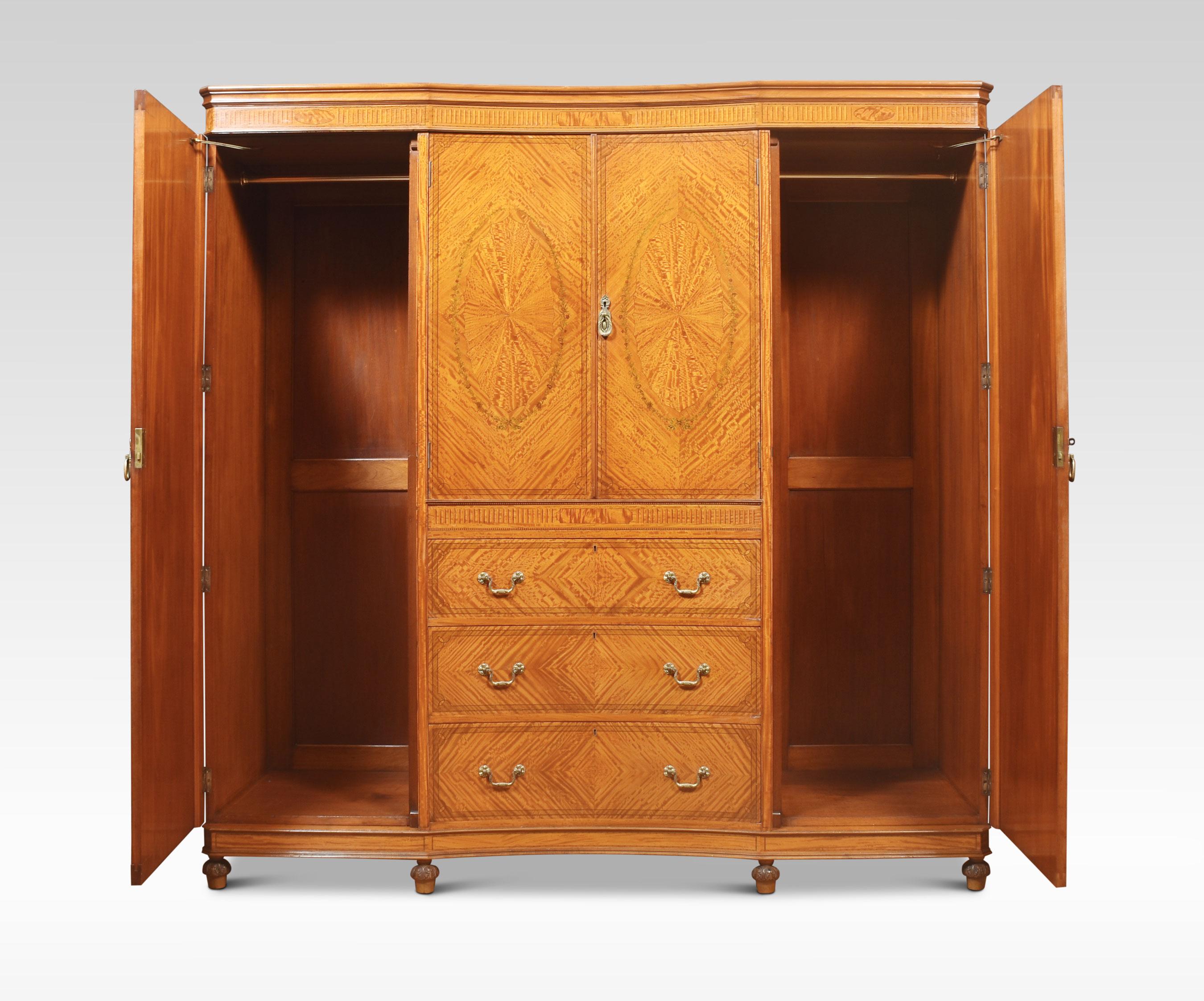 Late 19th century Sheraton Revival compactum wardrobe, the detachable decorated concaved cornice above a central cupboard fitted with hanging rail enclosed by a pair of floral inlaid panel doors. Above a secret drawer and three long graduated