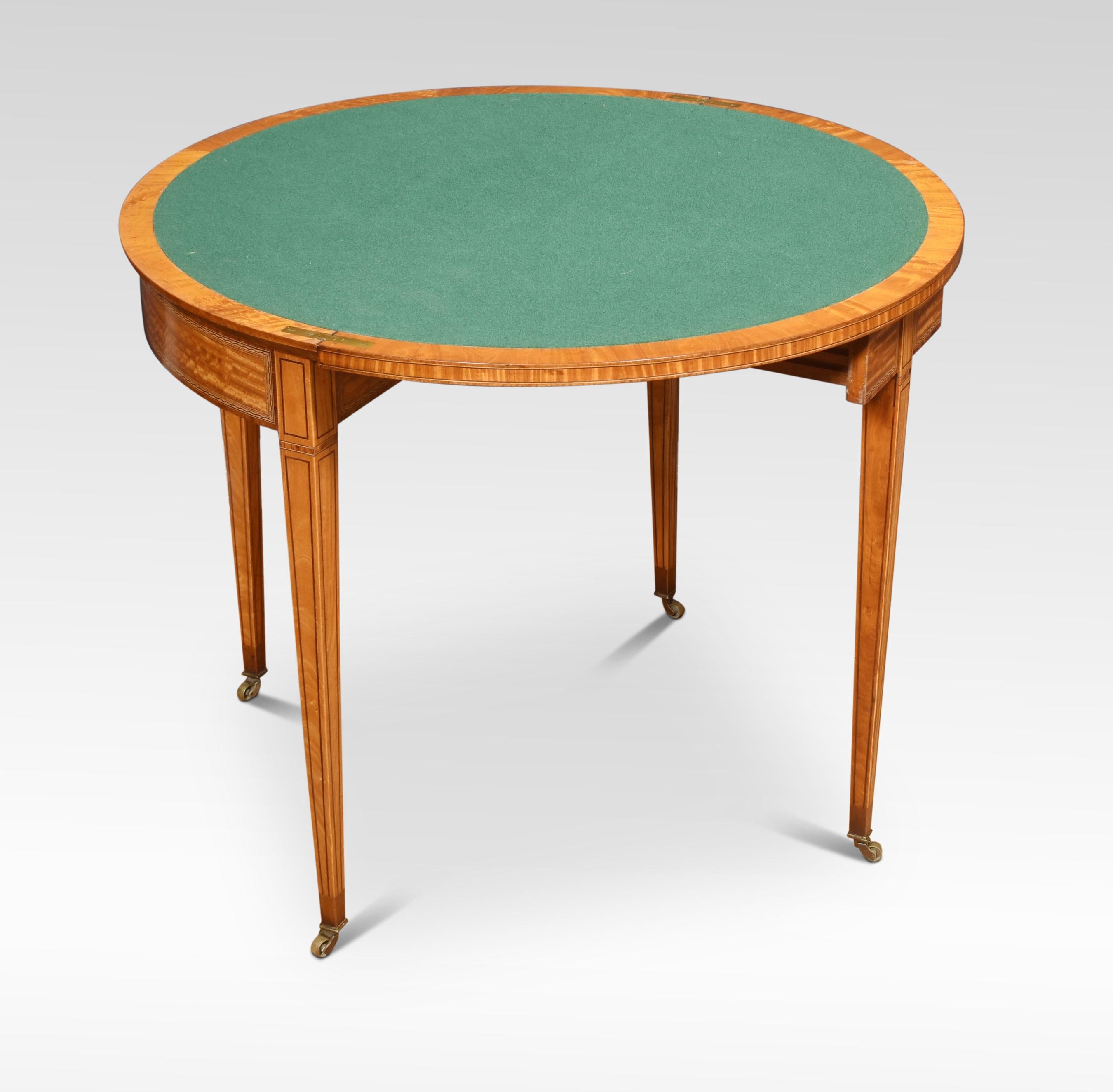 Demilune card table the satinwood top with banding. To the fold-over top opening to reveal the inset green baize card table. The molded frieze raised up on tapering legs and spade feet. Terminating in brass casters.
Dimensions
Height 30