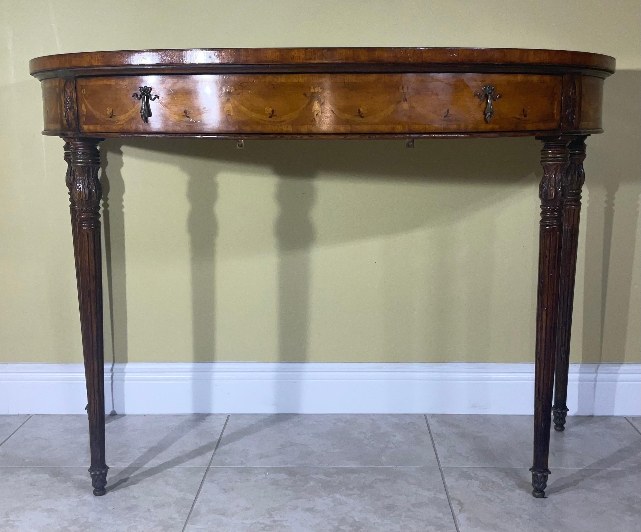 
An extremely fine Satinwood Pier table,  decorated and finely inlaid with fruit woods and depicting vine and flowers , elegant hand carved legs, with bronze and brass hardware, one top draw. In the back of table two pieces of metal attached the can