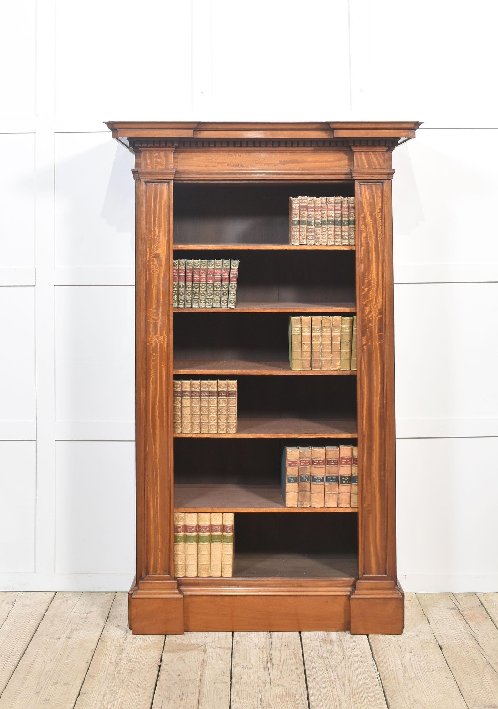 19th-century satinwood open bookcase of architectural form, the stepped moulded cornice and dentil moulded frieze above five adjustable shelves flanked with fielded pilasters and panelled sides all raised up on a plinth base.
Dimensions
Height 71