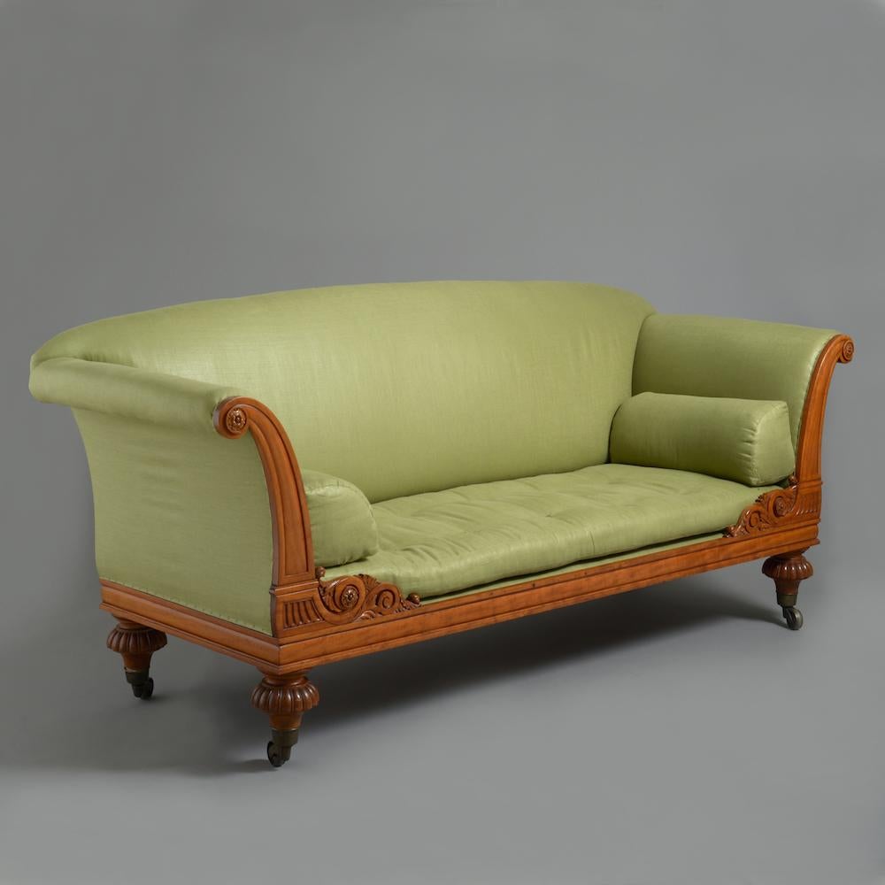 A George IV satinwood sofa, circa 1830.

Original brass socket castors.