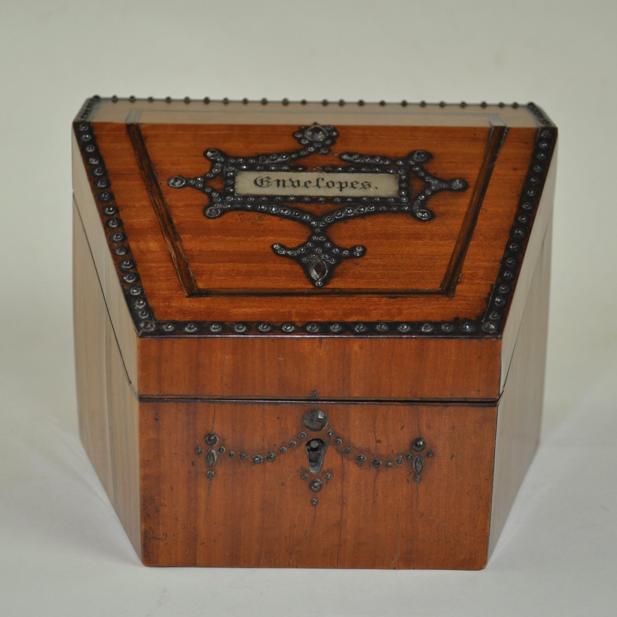 A fine quality and small 19th century figured satinwood stationery box with inlaid line decoration and roes of silvered pins to the top. The slant front inlaid with the word 
