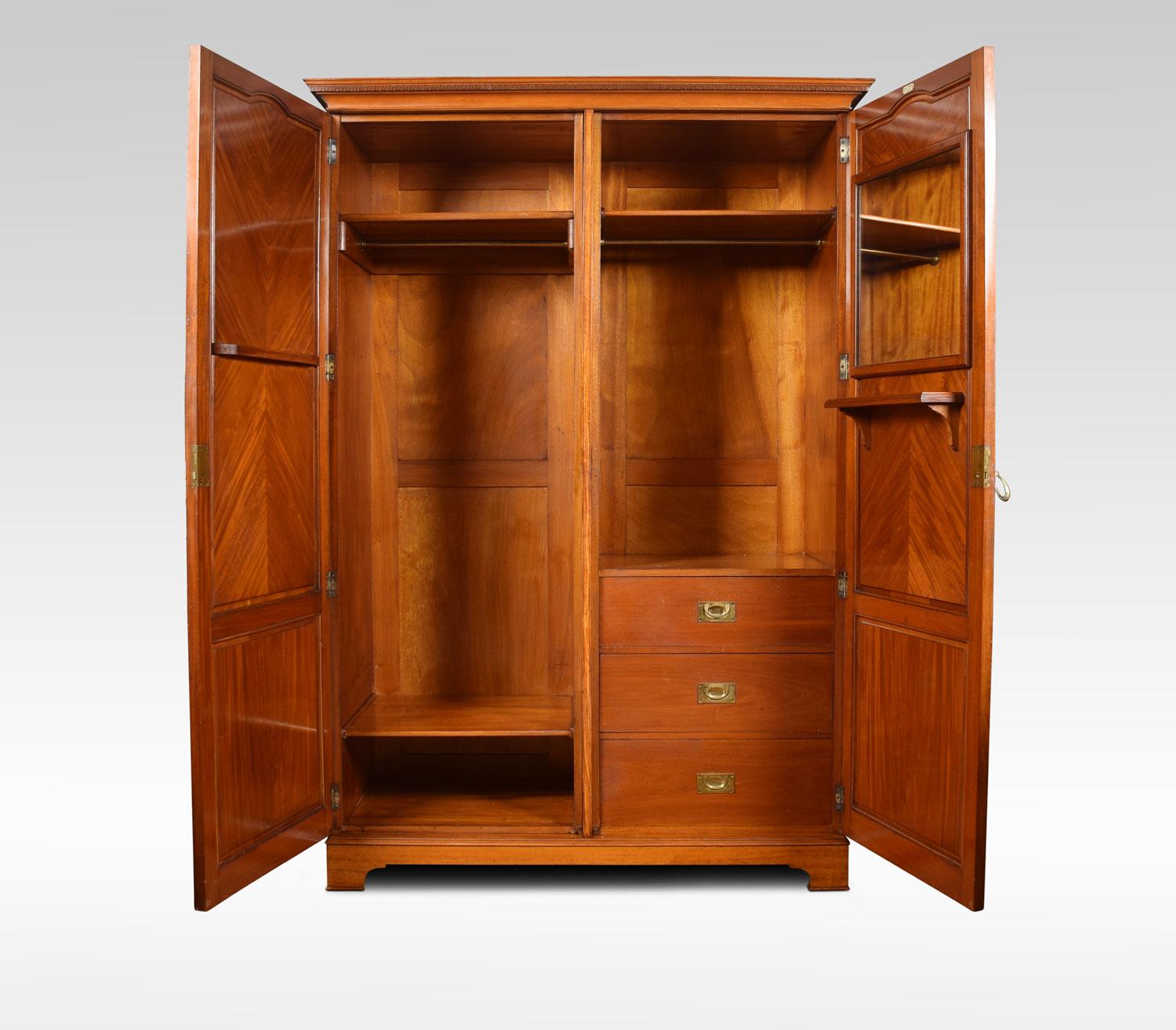 Early 20th century satinwood wardrobe by S & H Jewell, 131 High Holborn, London. The projected molded and Greek Key cornice, over a pair of quarter veneer and inlaid paneled doors. Enclosing polished interior, fitted with hanging space and drawers.