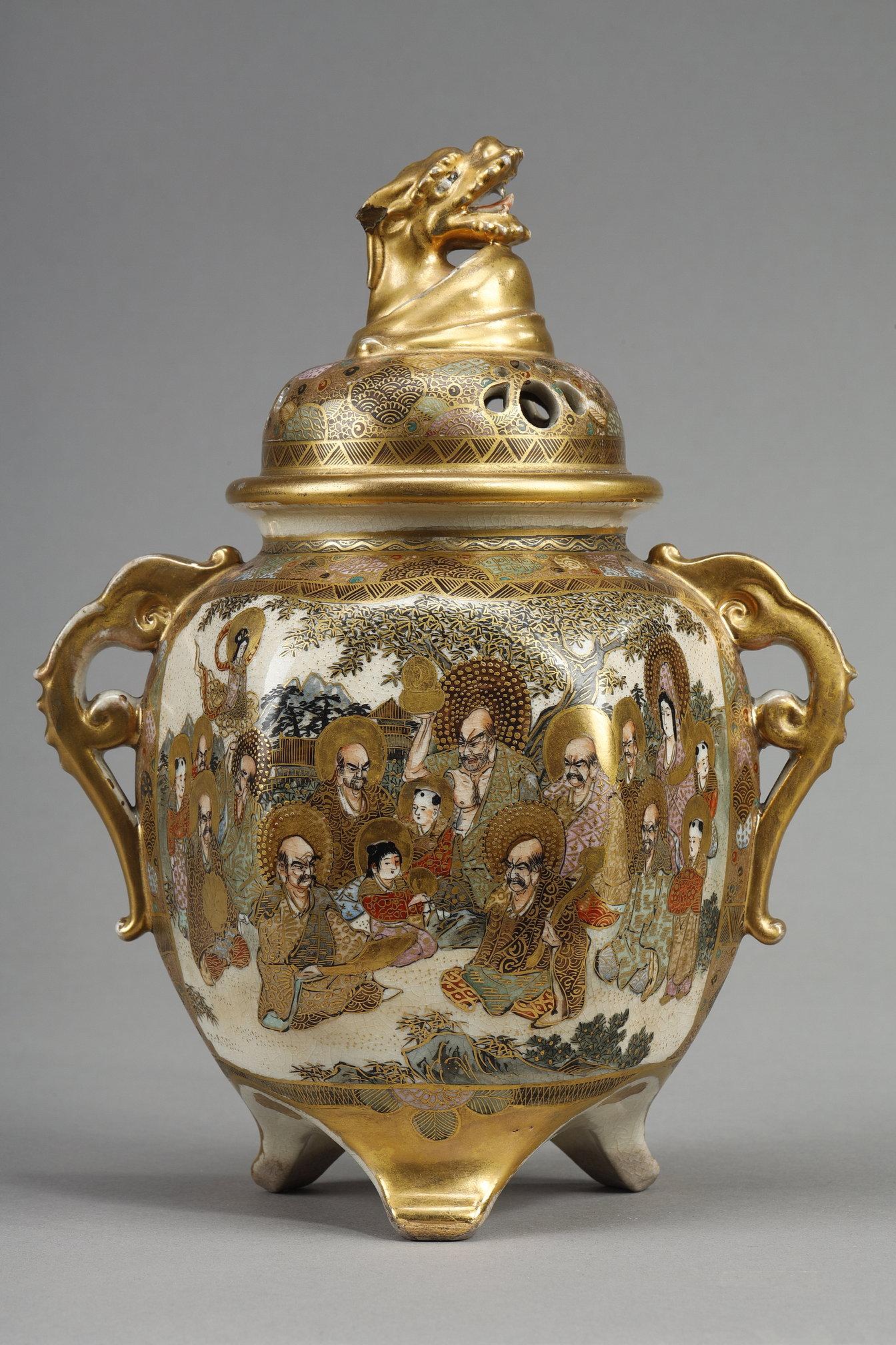 Satsuma earthenware tripod perfume burner with polychrome and gold enamel decoration. The body is decorated on one side with richly dressed figures representing masters instructing two young children, and on the other with scenes of daily life. The