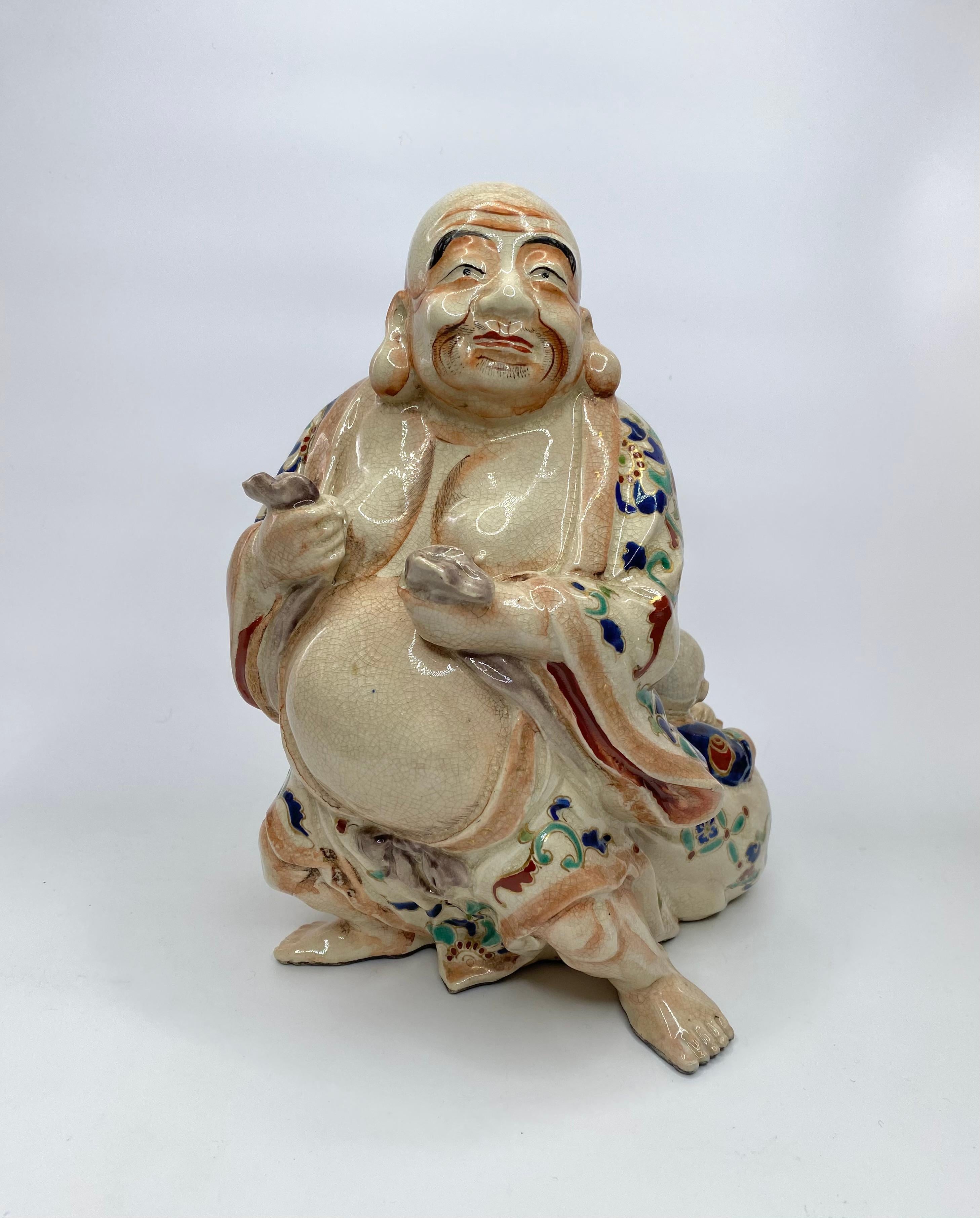 Satsuma pottery figure group, Japan, c. 1890, Meiji Period. The large group, modelled as Hotei standing, with his corpulent belly sticking out of his robes. He drags his large sack, within which, are seated, two smiling boys, carrying a large