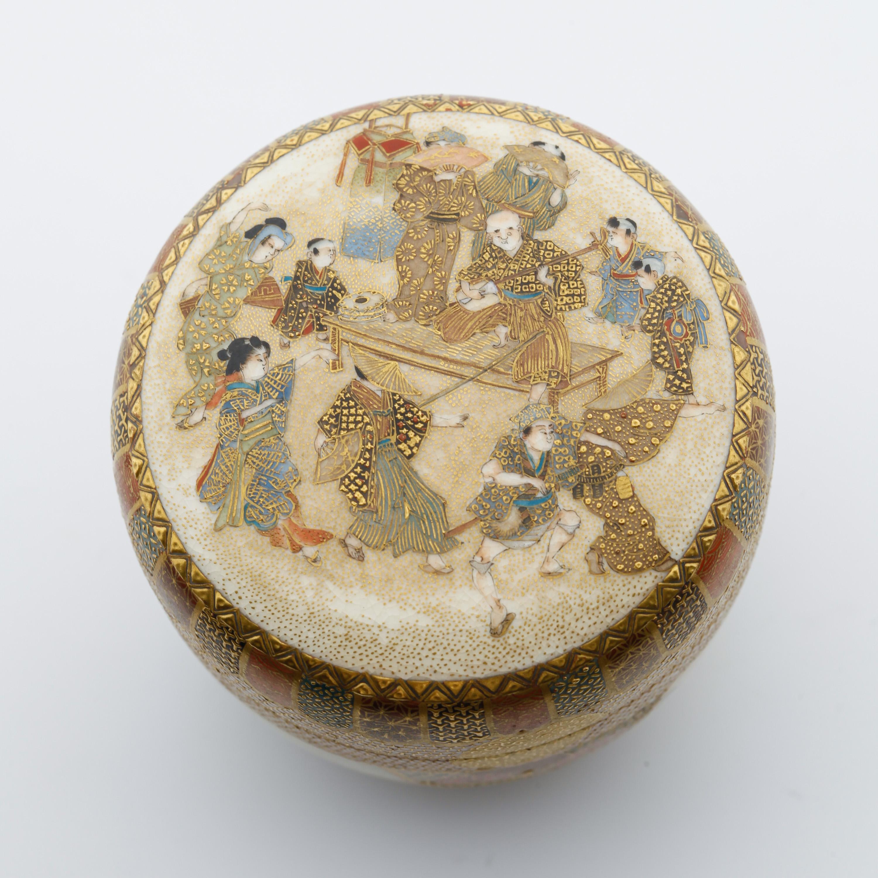 Title: Satsuma tea caddy with figures.
Date: Late 19th century
Dimensions: 6.2 x 5.8 cm

A satsuma tea caddy and cover decorated with a lakeside view, maple leaves and a musical performance. 

Counterbalancing different subjects and themes,