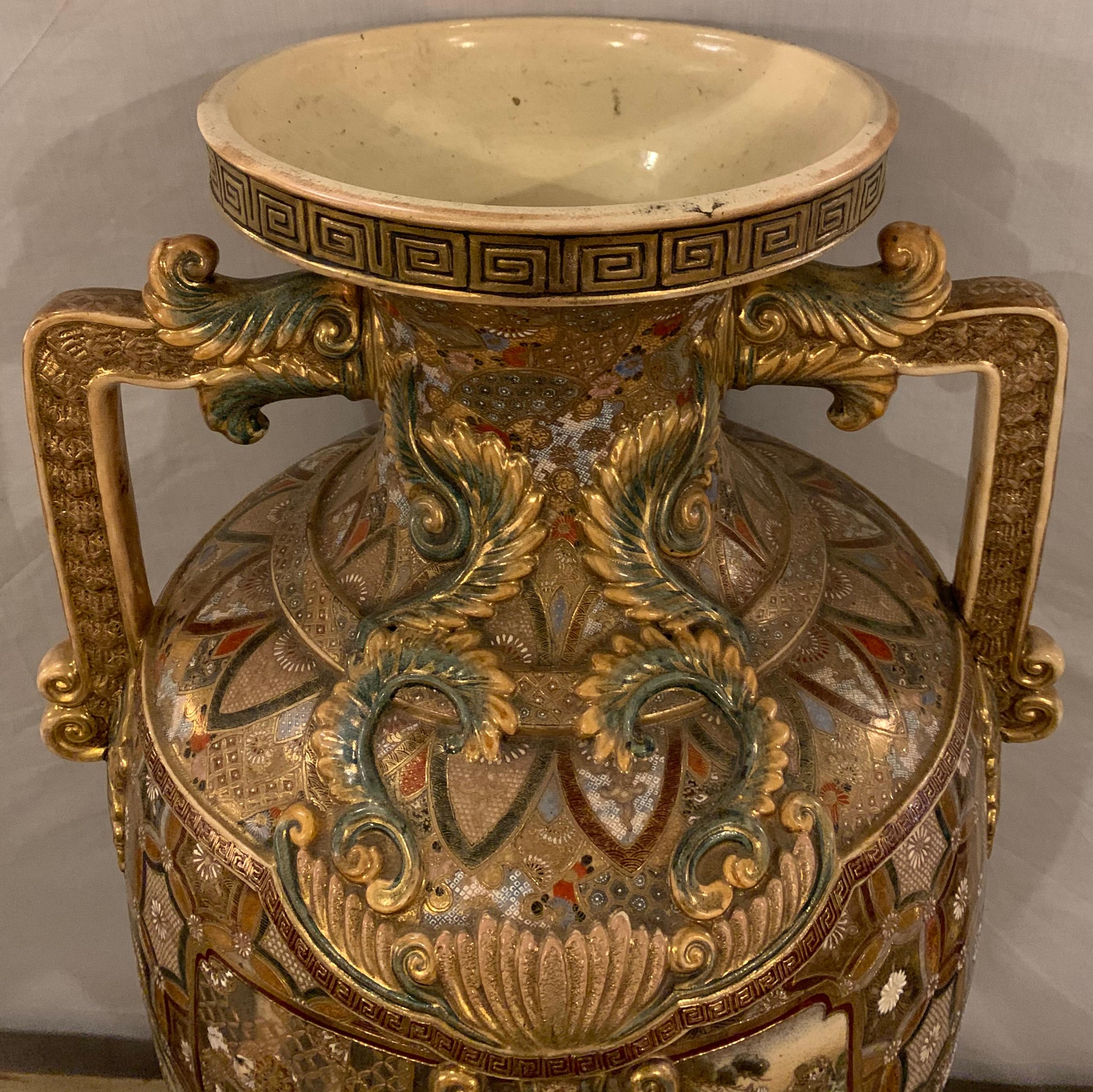 Satsuma thousand face vase or urn palace sized twin handled 35.5 inches high having a gilt Greek key designed rim.

Greg
SXXX/ESAA.