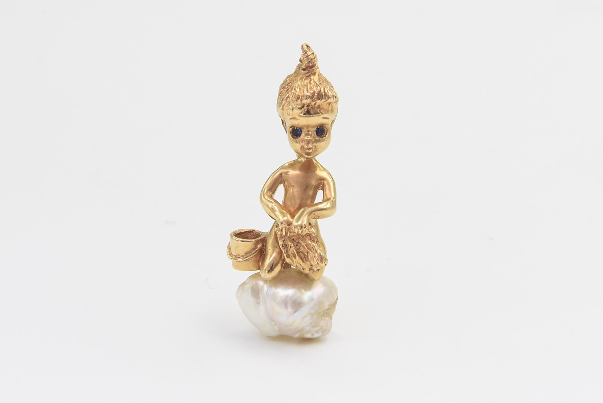 This brooch is a great example of Ruser's children of the week line. This brooch features a child kneeling on a freshwater pearl next to a pail with a towel in its hands.  This is a smaller (1.65