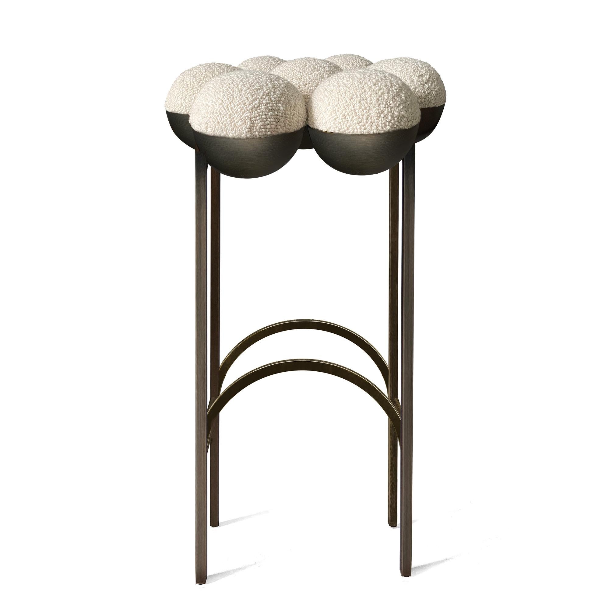 The equally singular Saturn bar stool utilizes the same gathered bilboquet seat construction, to create a more simplified but still incredibly distinctive form. The sumptuously undulating seat instantly appeals with its invitingly upholstered