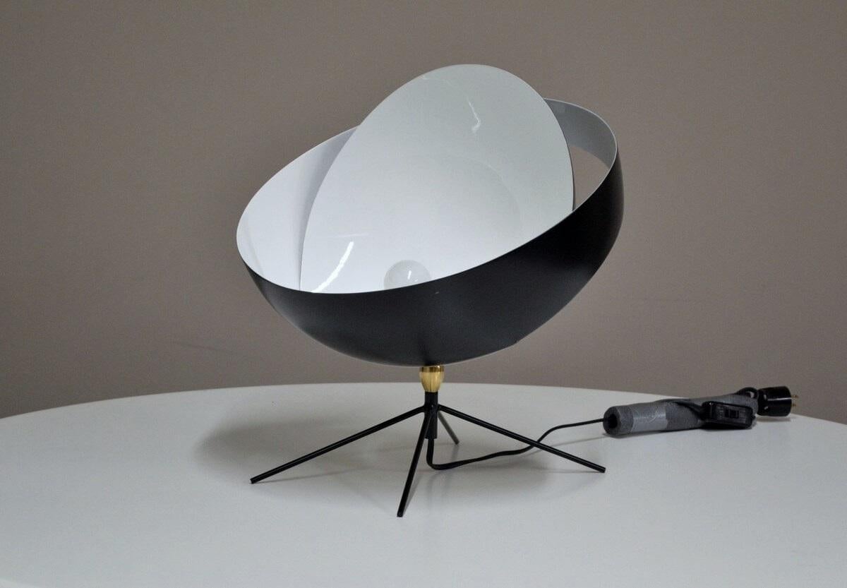 Taking the planet as inspiration, this desk lamp is a unique source of light, comparable to an eclipse. At the time, it was a revolutionary piece of metal work.

Mounted on a brass swivel, with four slender yet very stable legs. A timeless lamp that