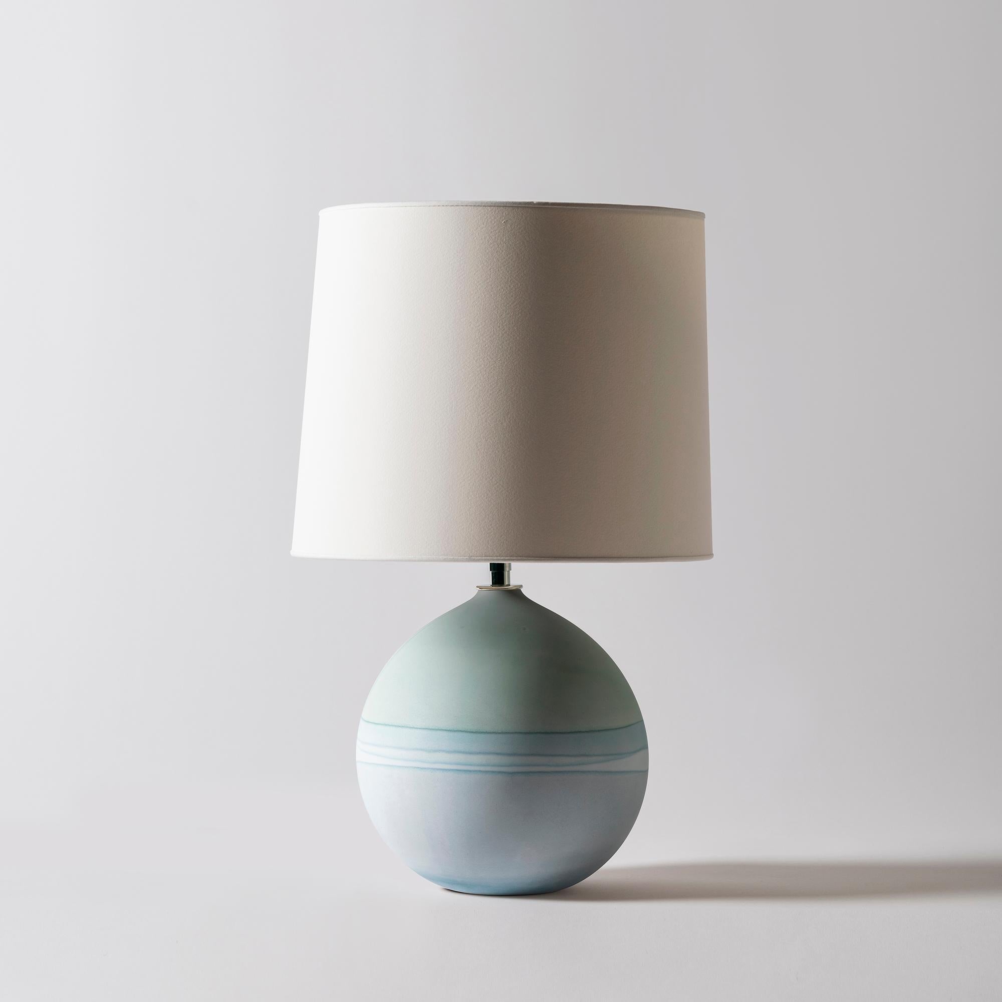 Saturn lamp in mint and grey by Elyse Graham
Dimensions: D31 x H49 cm
Materials: Plaster, Resin, Cotton rag Paper, brass, Nickel. Hardware: polished nickel-plated brass uno threaded socket
with turn key switch, in-line dimmer.
Molded, dyed, and