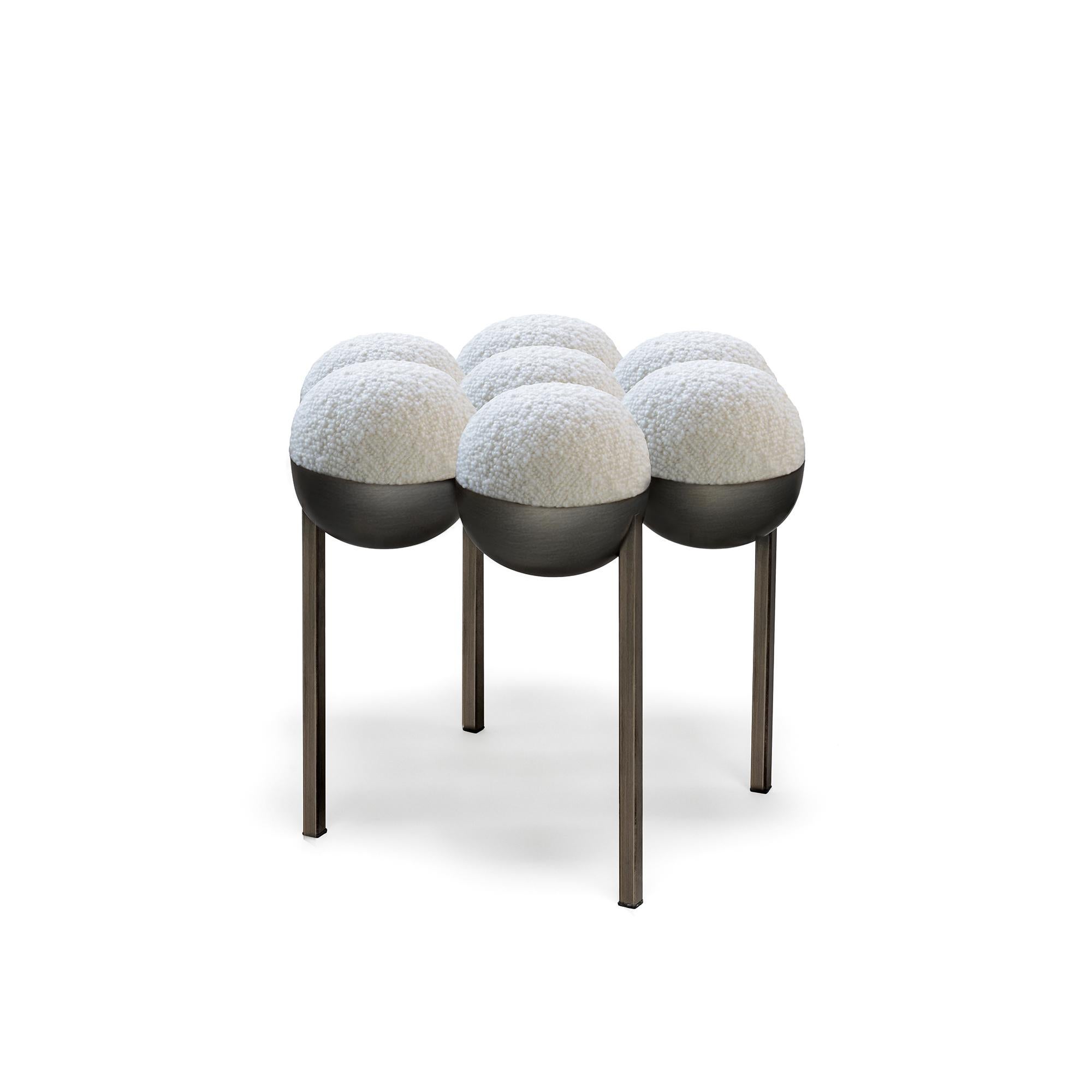 The equally singular Saturn pouffe utilizes the same gathered bilboquet seat construction, to create a more simplified but still incredibly distinctive form. The sumptuously undulating seat instantly appeals with its invitingly upholstered comfort,