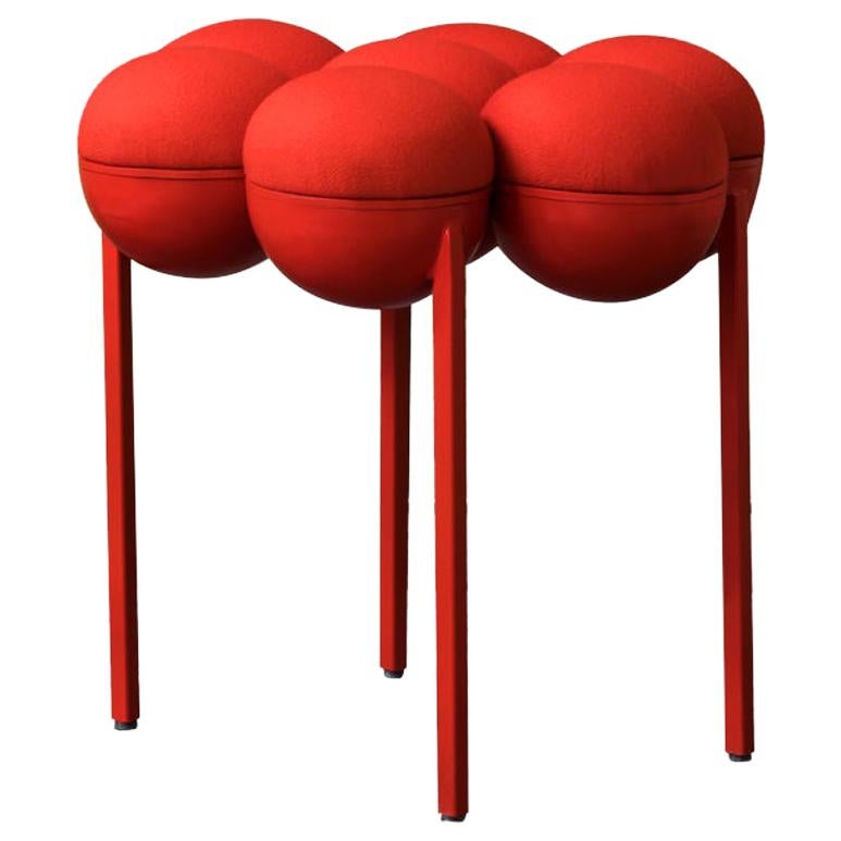 The equally singular Saturn pouffe utilizes the same gathered bilboquet seat construction, to create a more simplified but still incredibly distinctive form. The sumptuously undulating seat instantly appeals with its invitingly upholstered comfort,