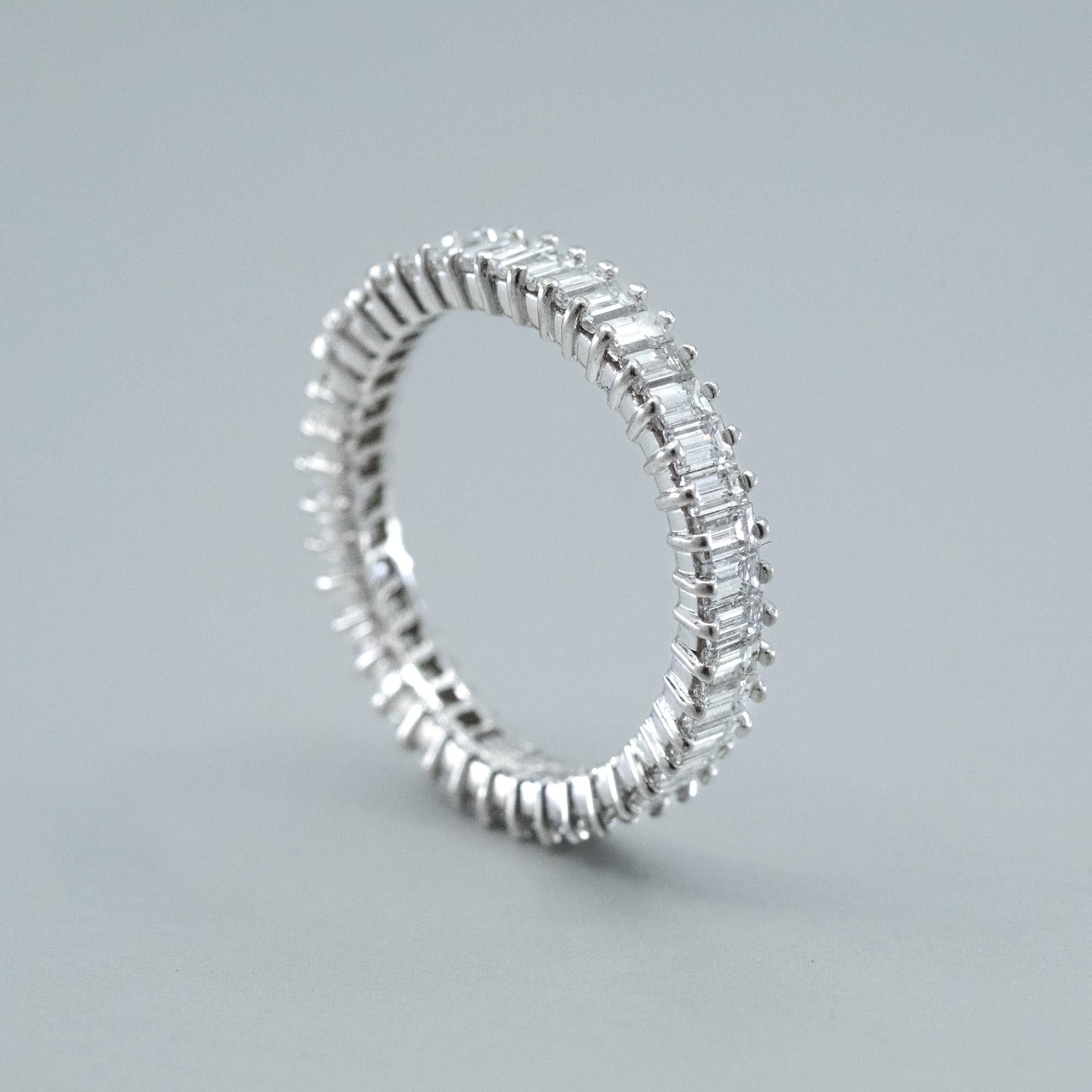 A Bunda Saturn Wire setting Diamond eternity ring, featuring baguette cut Diamonds in platinum. Signed
Bunda.
Characteristics of Baguette Cut Diamonds; 42 = 3.00ct, F colour / VS Clarity.
Total weight: 3.11 grams