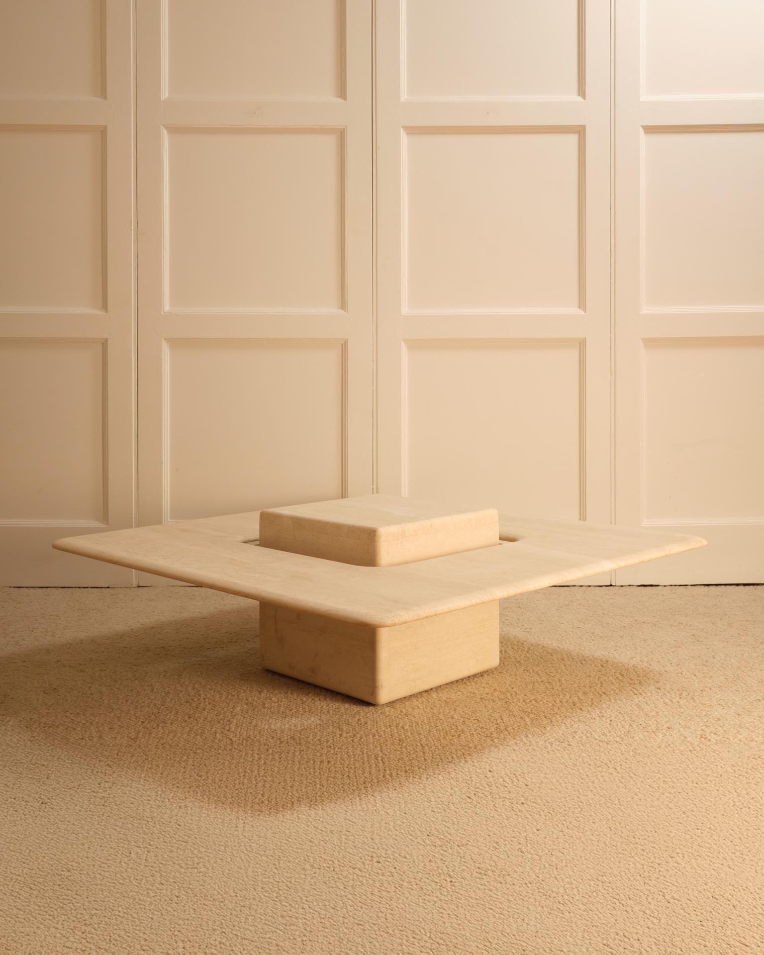 Travertine coffee table - Saturne model - Claude Berraldacci - France, 1980s

Square table with rounded edges. Features an impression of a floating ring resting on a glass plate around a central travertine base.
Very good condition.

- Dimensions: