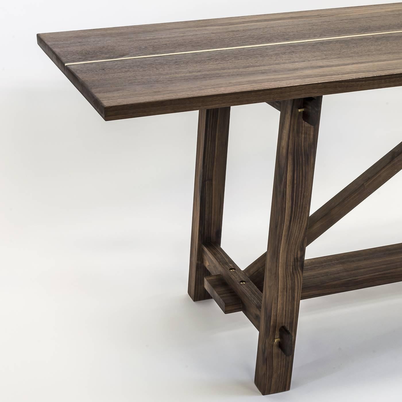 Handcrafted of solid walnut wood, this remarkable piece is a so-called 