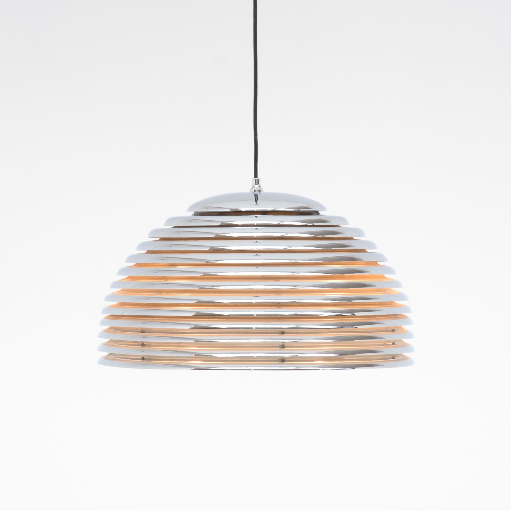 The Saturno pendant lamp was designed by Kazuo Motozawa for Staff Leuchten, in Germany, 1972.
The dome shade is made of chromed metal rings, white lacquered inside. The Saturno pendant lamp creates the perfect light above a dining table.
This lamp